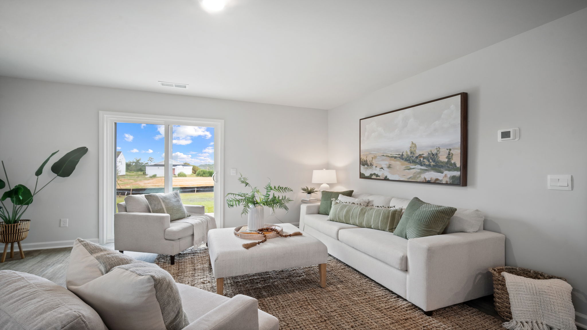 Bright family room in The Retreat at East Argent Robie home with modern open layout