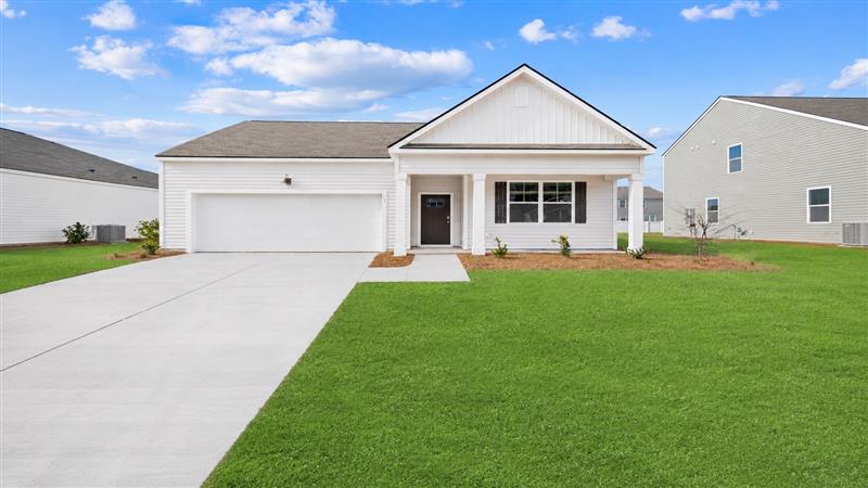 Front of home Cali S with large green grass yard in east argent