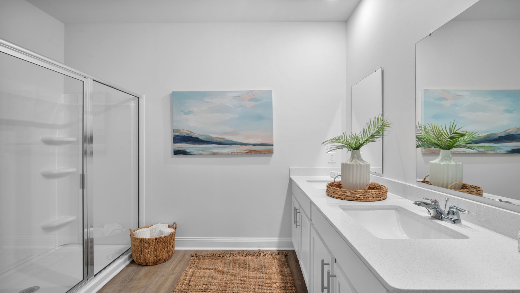 Luxurious primary bathroom in the Aria floor plan featuring dual vanities, a spacious walk-in shower, elegant finishes, and a spa-inspired retreat atmosphere.