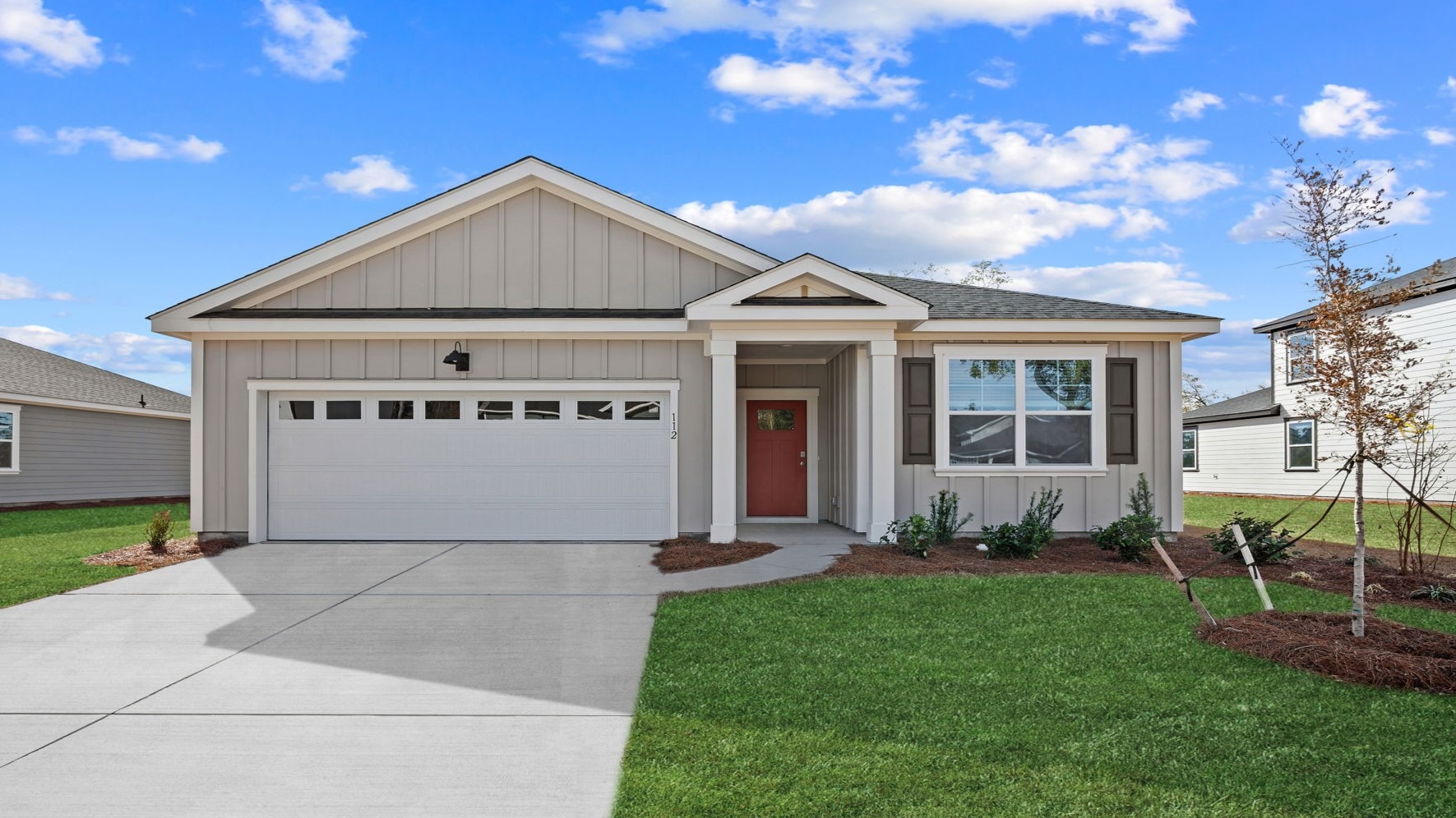 Stunning Aria floor plan home at East Argent featuring exceptional curb appeal, modern Lowcountry architecture, a two-car garage, and professionally landscaped grounds.