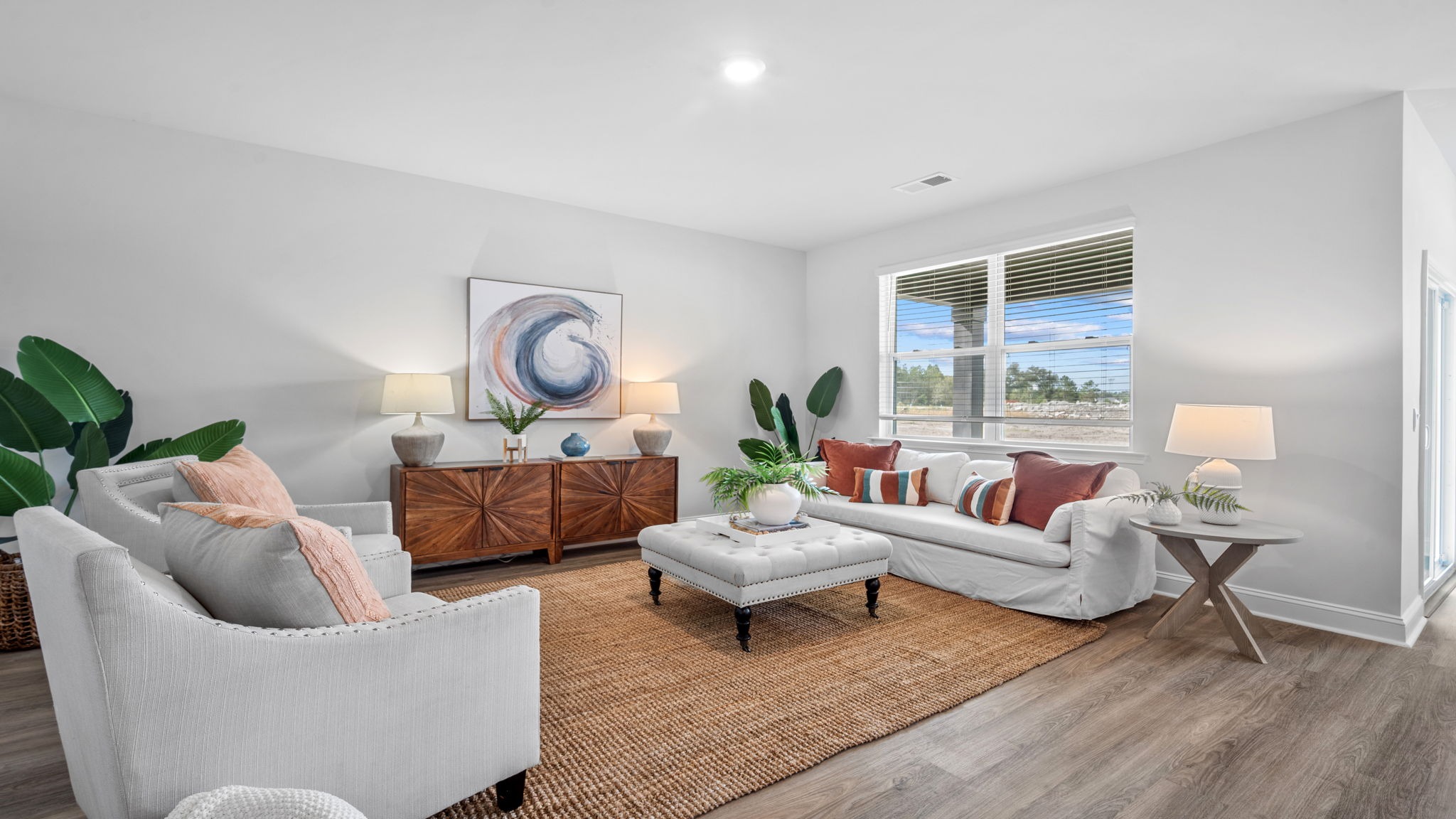 Spacious great room in the Aria floor plan showcasing open-concept living, large windows, and comfortable entertaining space.