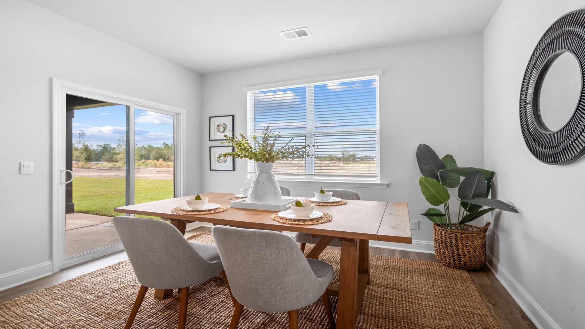 Elegant dining room in the Aria floor plan featuring open-concept design, abundant natural light, and seamless connection to the gourmet kitchen.