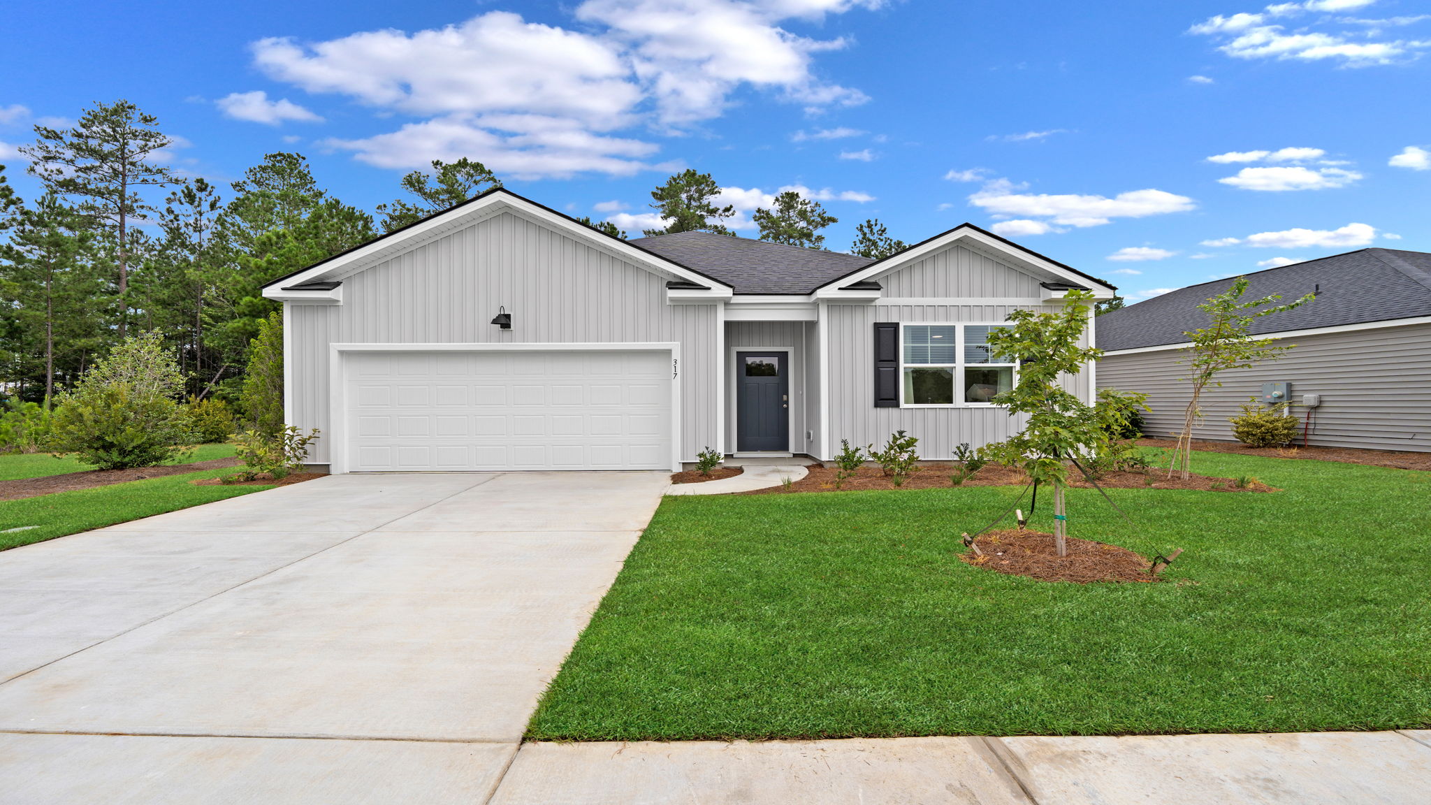 Cali floor plan exterior by D.R. Horton featuring attractive curb appeal, professional landscaping, energy-efficient construction, and a two-car garage.
