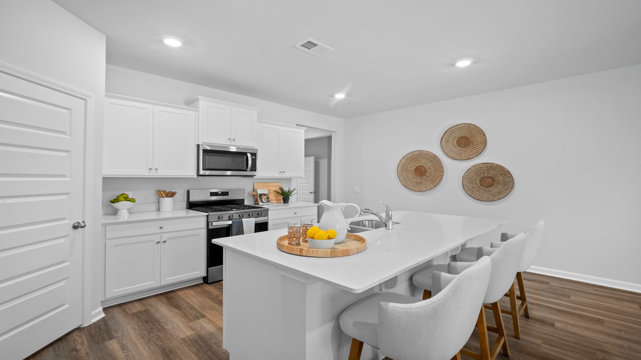Spacious kitchen with island seating, abundant storage, and direct views of the dining and living areas, perfect for entertaining.