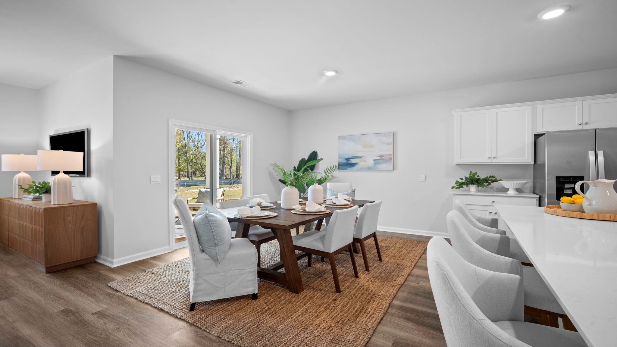 Open dining room connecting the kitchen and great room, creating a welcoming atmosphere for shared moments.