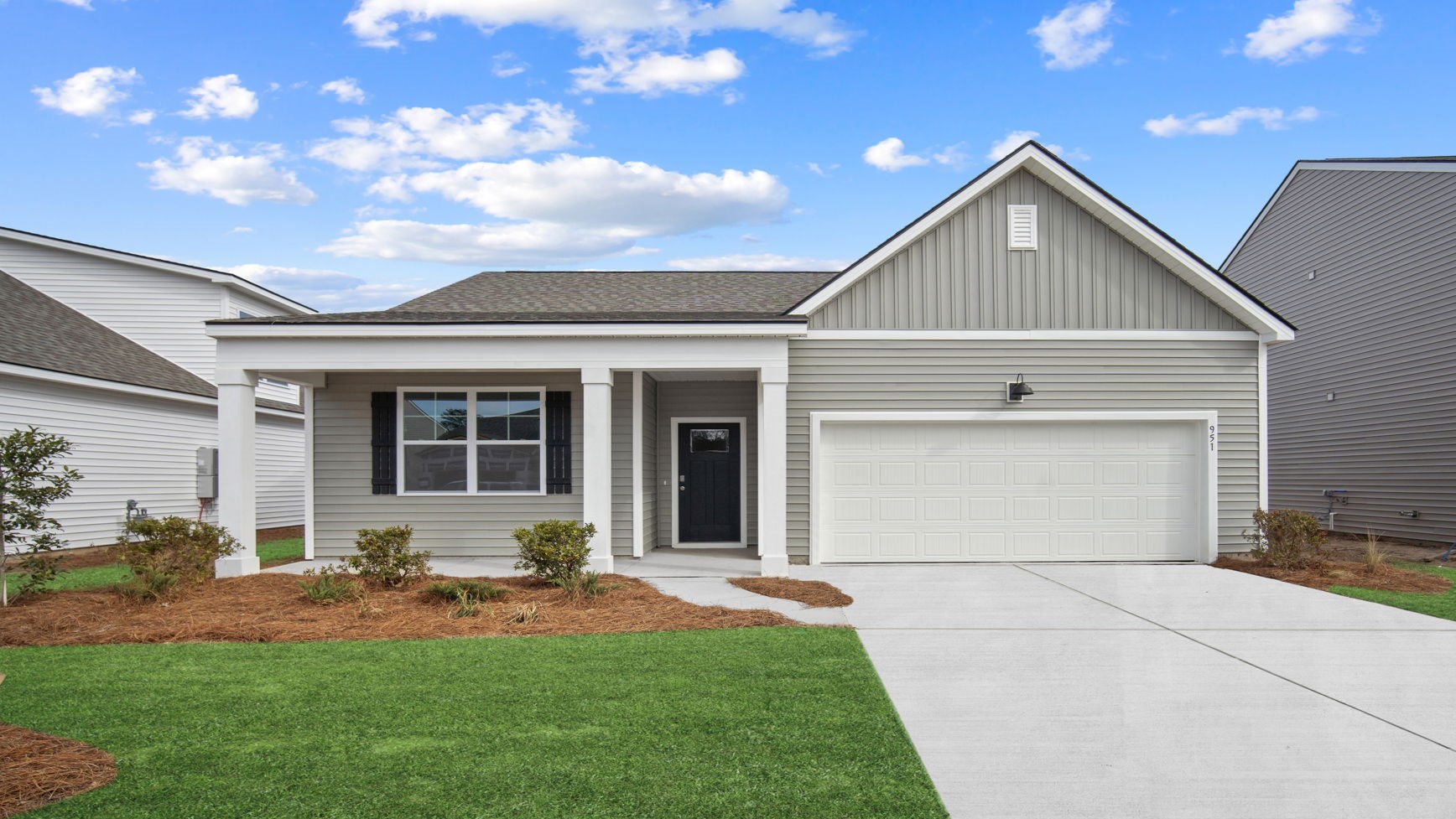 Beautiful Cali floor plan home in East Argent featuring exceptional curb appeal, a two-car garage, professional landscaping, and a welcoming covered entry.
