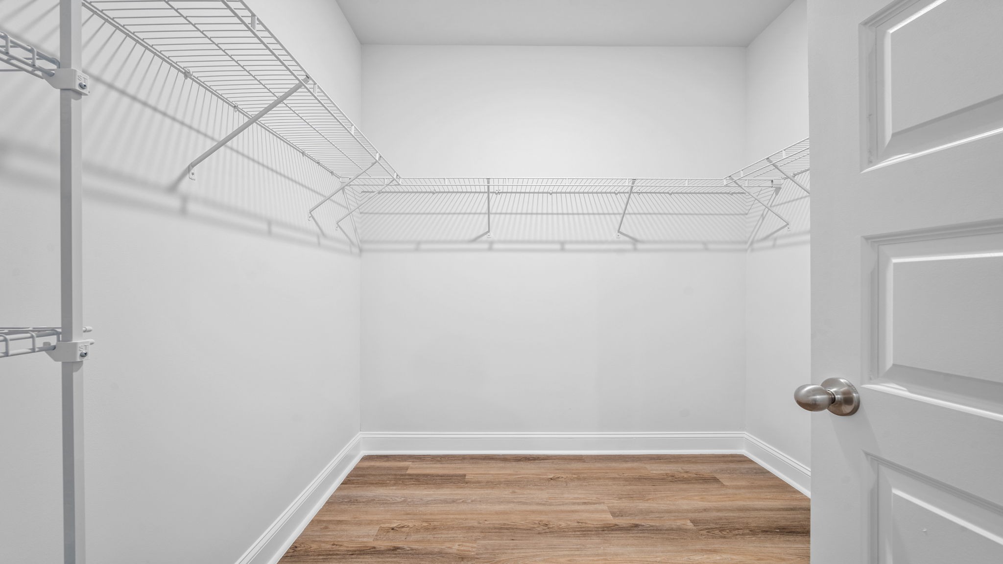 Spacious walk-in closet in the Cali floor plan offering abundant storage, shelving, and organization space within the private owner's suite.
