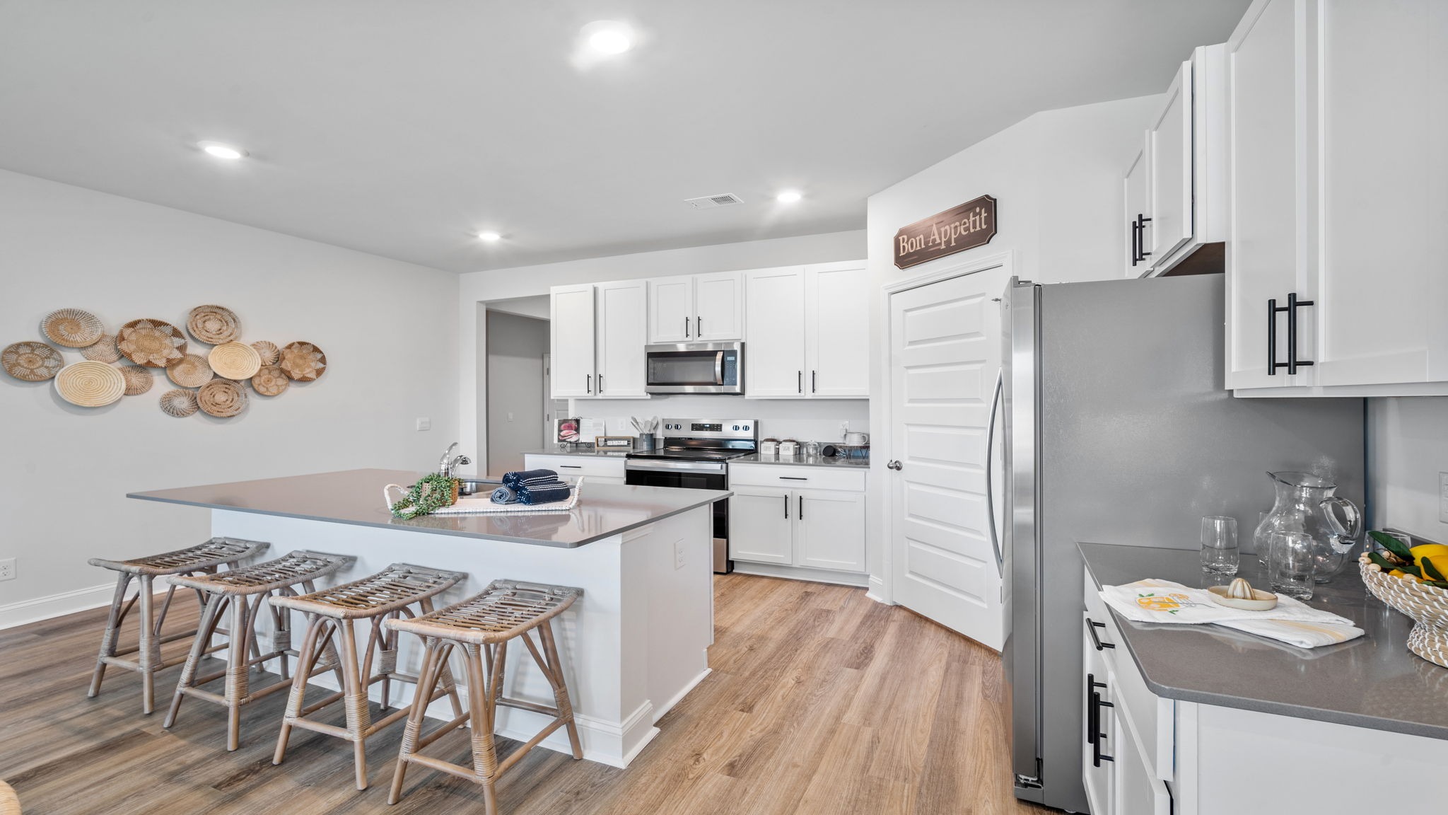 Gourmet kitchen in the Cali floor plan at East Argent featuring granite countertops, stainless steel appliances, a large center island, and abundant cabinet storage.