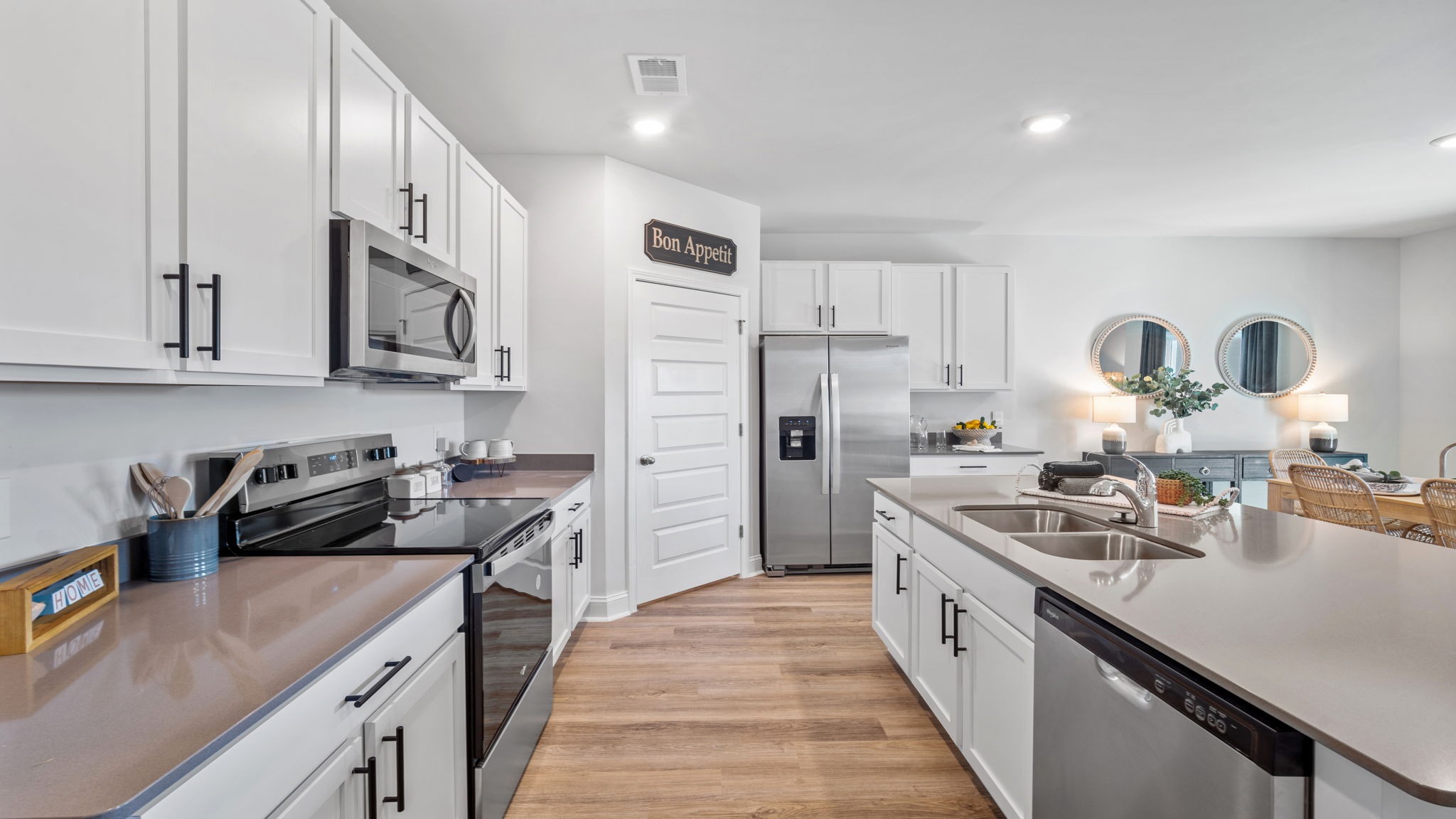 Open-concept kitchen with modern finishes and island seating, seamlessly connected to the living and dining areas in the popular Cali floor plan.