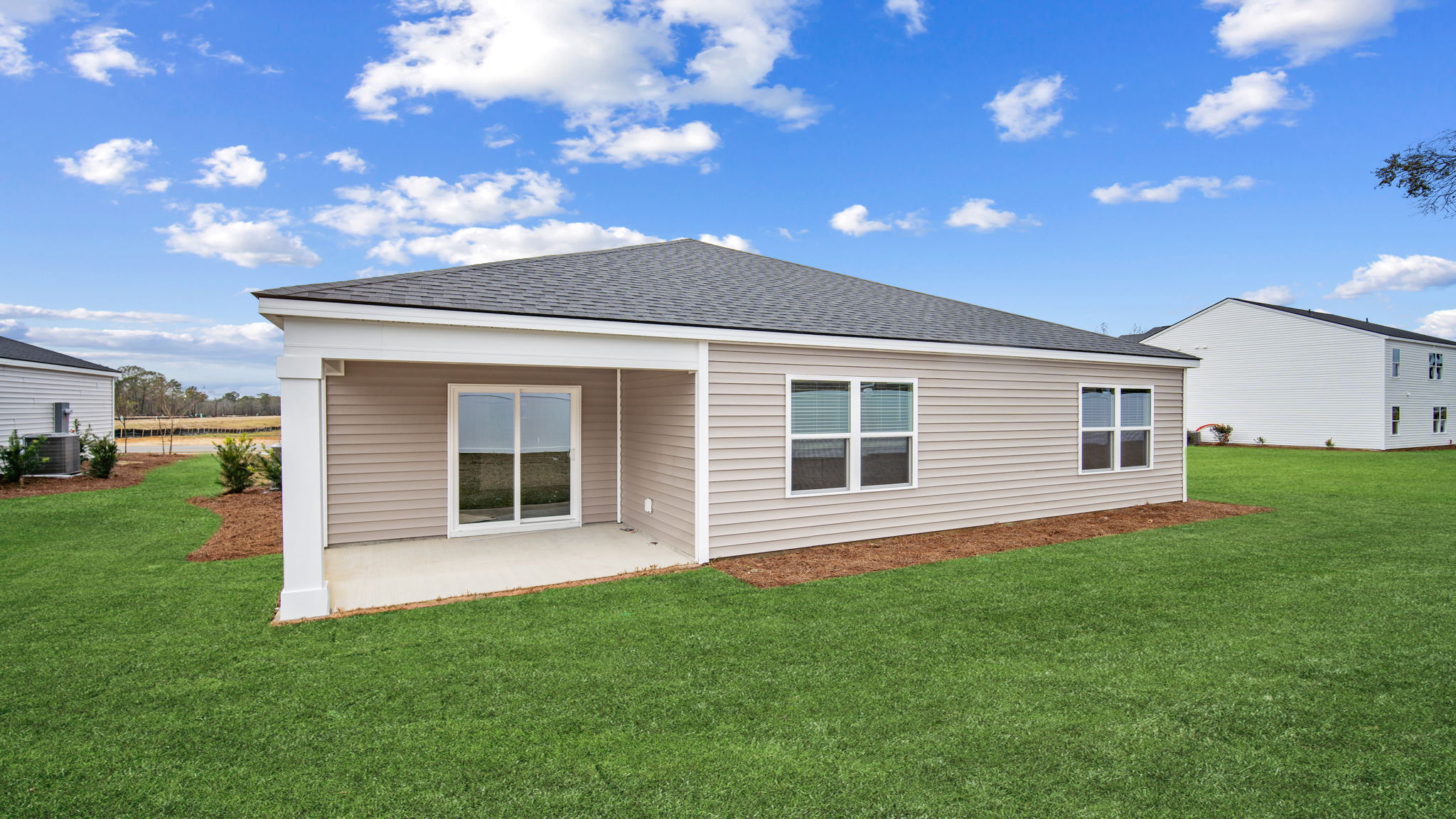 Cali rear exterior with covered porch and beautiful yard