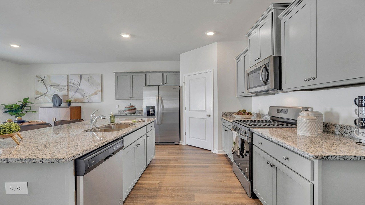 Kitchen walkway with counters on both sides