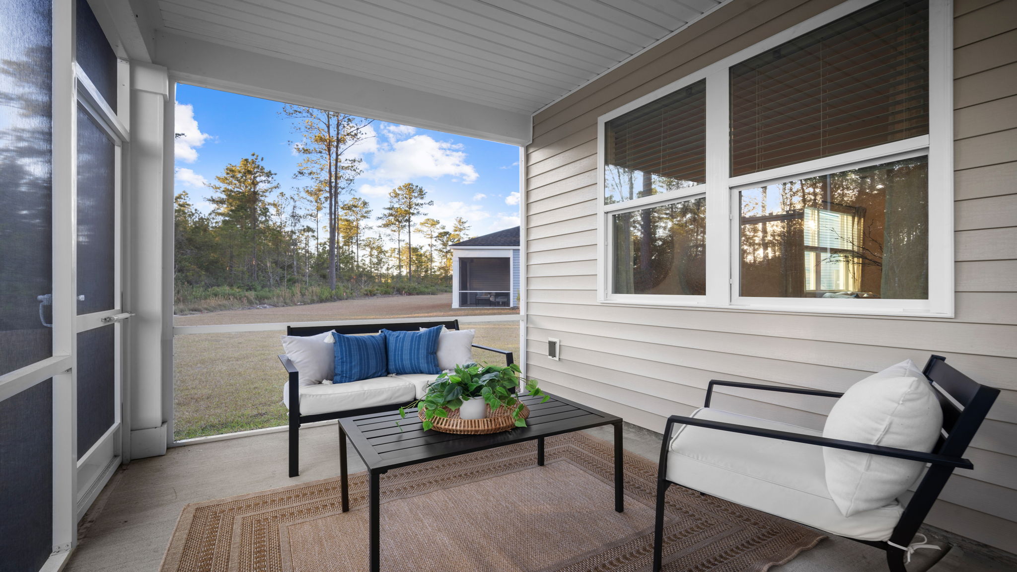 Screen porch decorated with seating