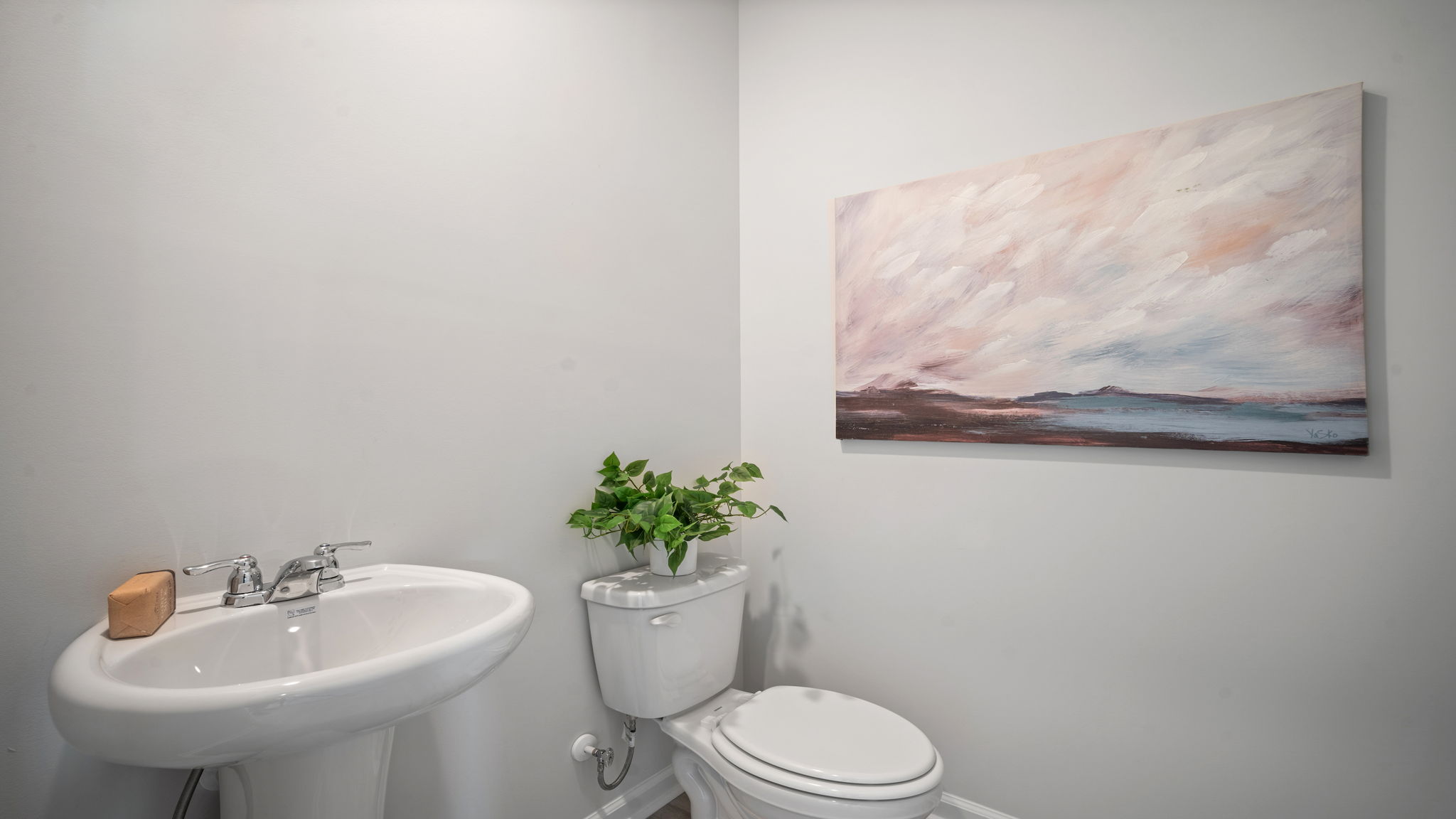 Half bathroom in the open concept living space.