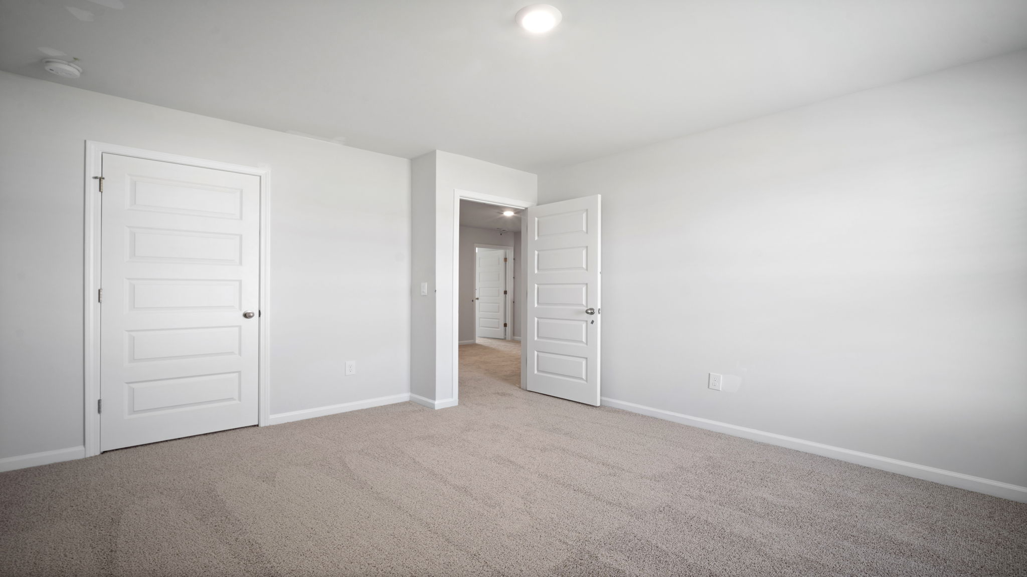 Bedroom with closet door and entry door.