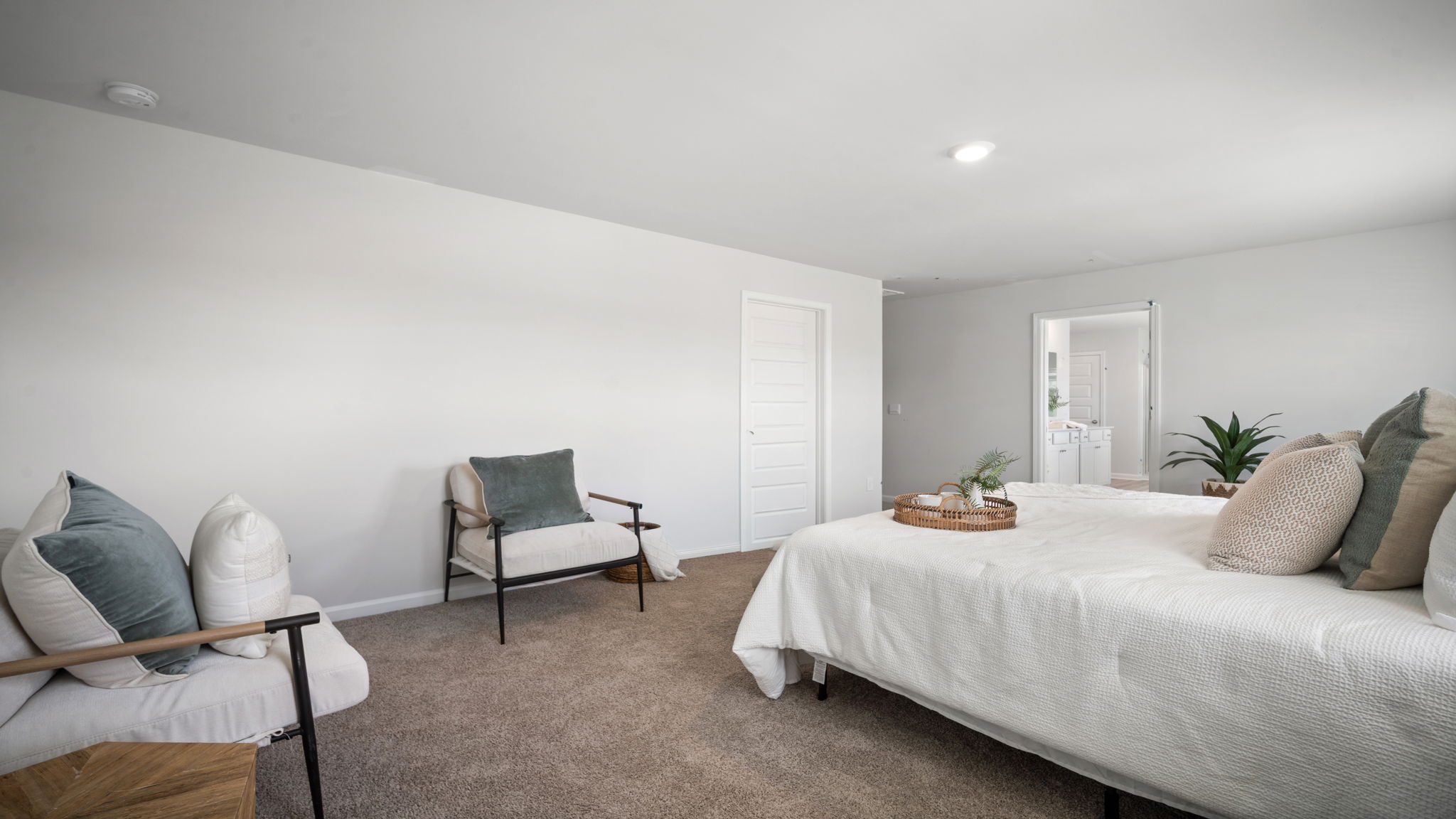 Primary bedroom with a bed and side table