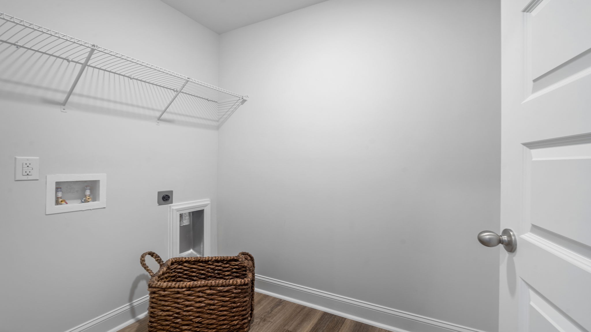 Dedicated laundry room in the Hayden floor plan featuring washer and dryer connections, storage space, and convenient household functionality.