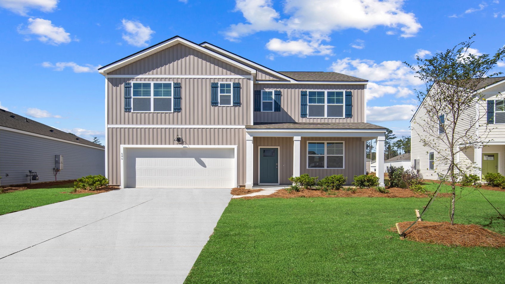 Hayden floor plan exterior by D.R. Horton featuring attractive curb appeal, modern architecture, professional landscaping, and an attached two-car garage.