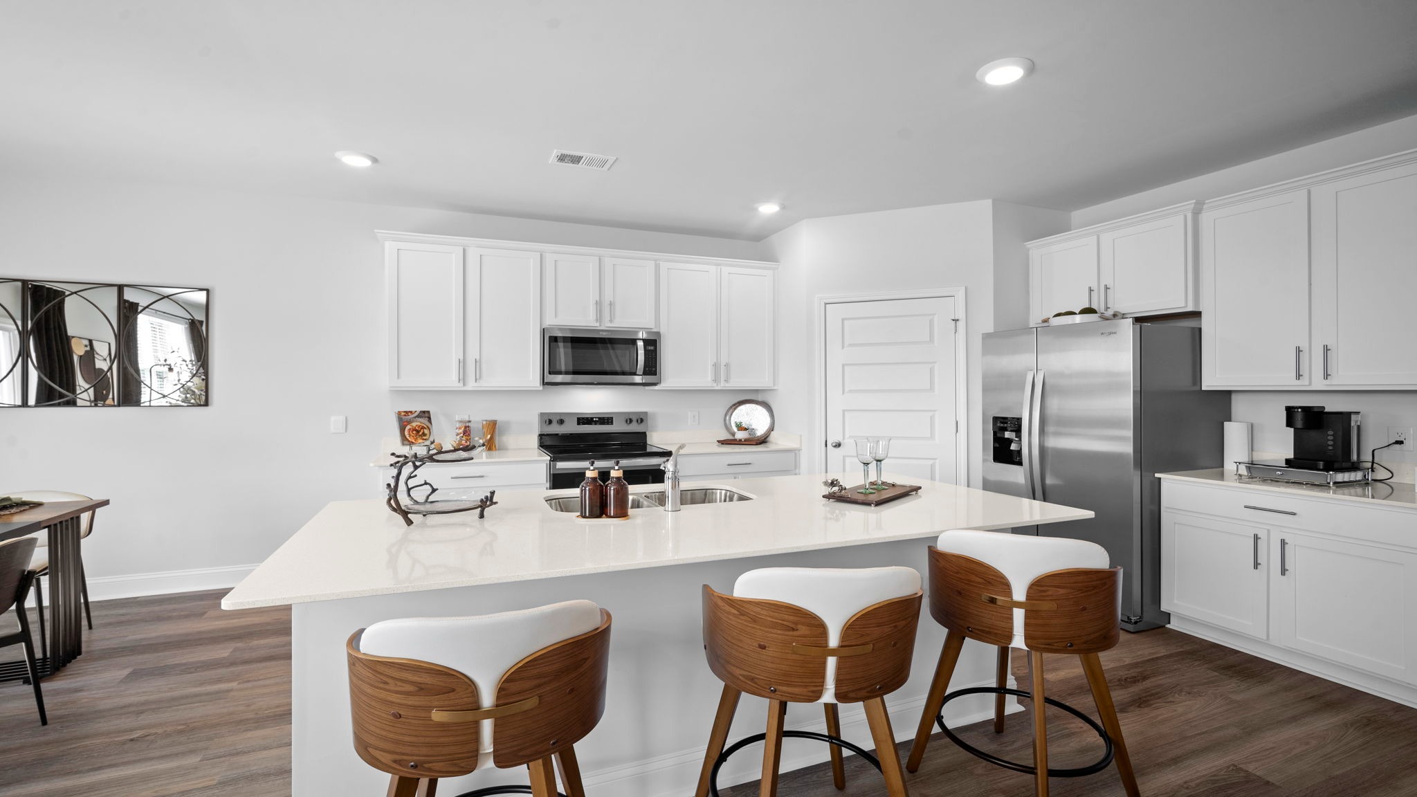 Modern dining room designed for hosting guests while maintaining seamless flow throughout the home's main living areas.