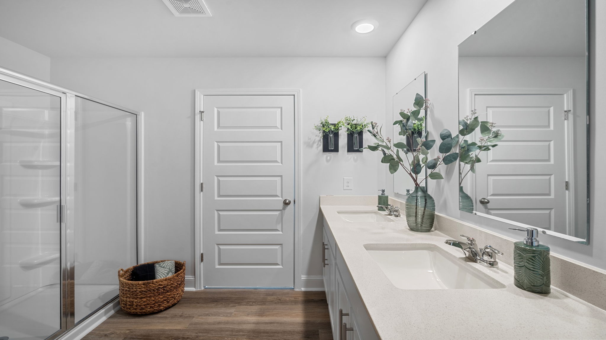 Spa-inspired owner's bath with contemporary finishes, generous storage, and functional design.