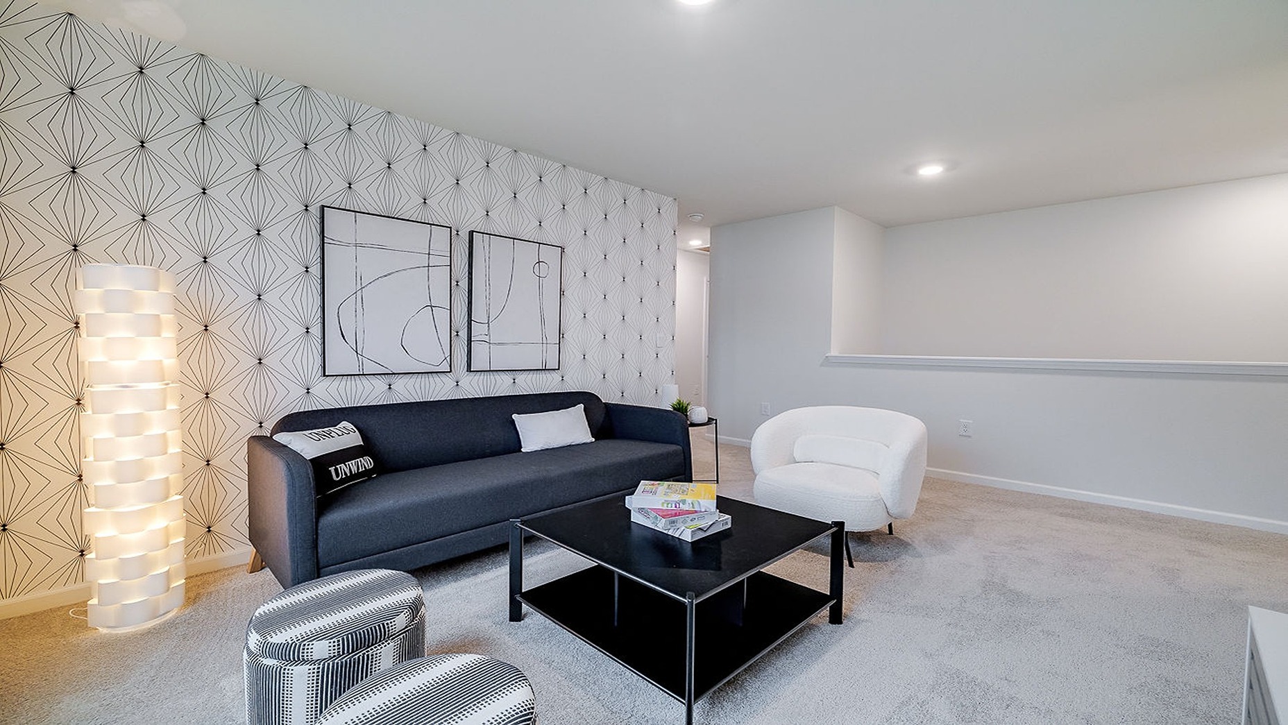 Upstairs living room with a couch, chairs and tv