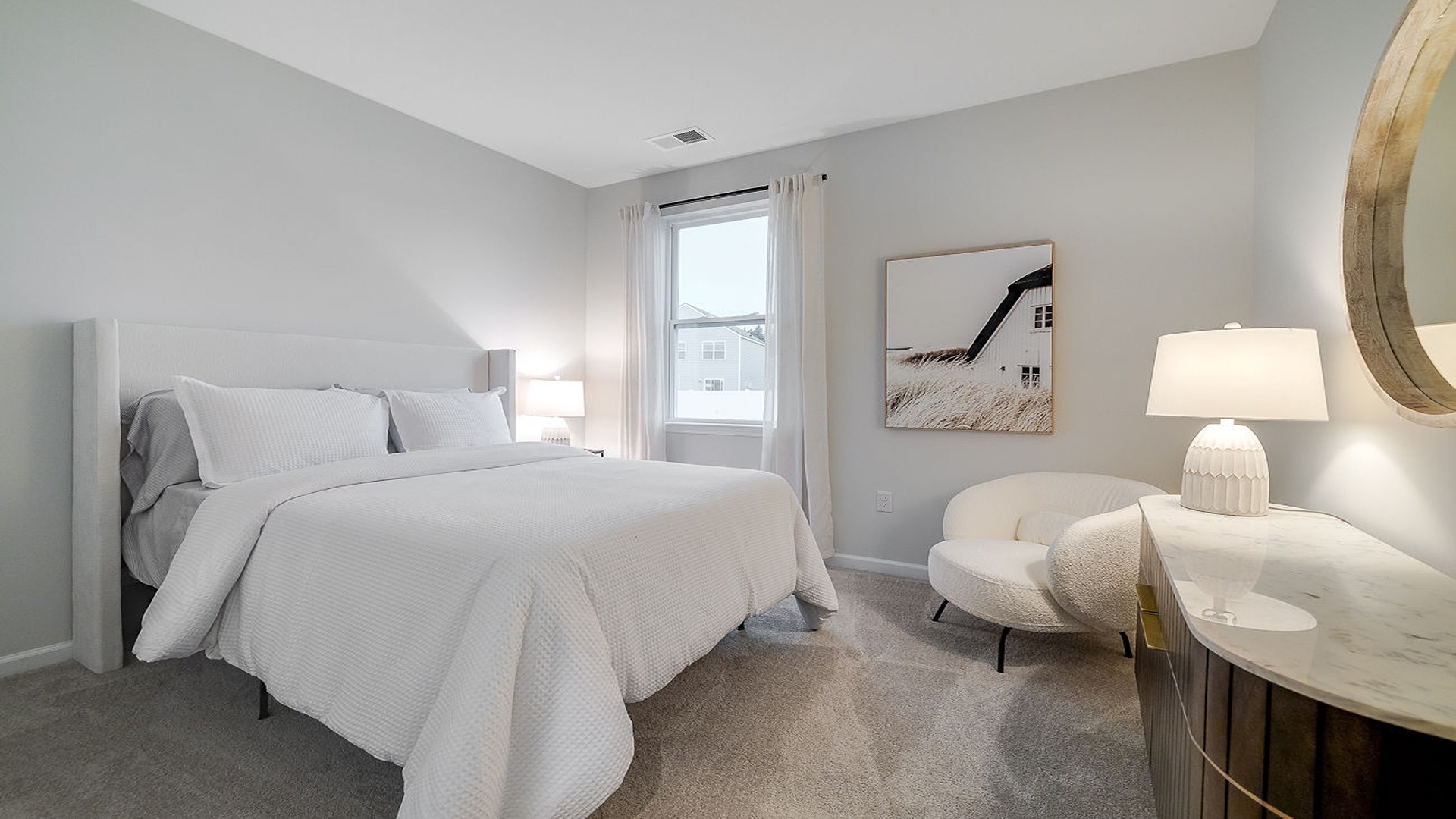 Downstairs guest bedroom decorated with a bed and chair