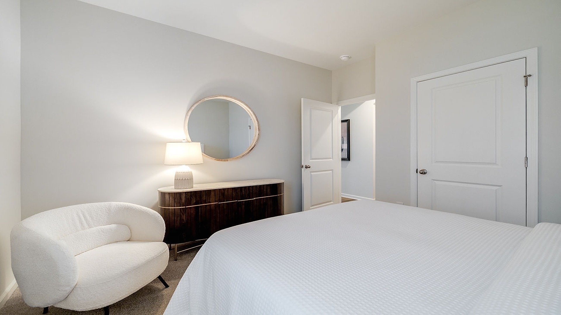 Guest bedroom view from inside looking out from the bed at a chair in the corner