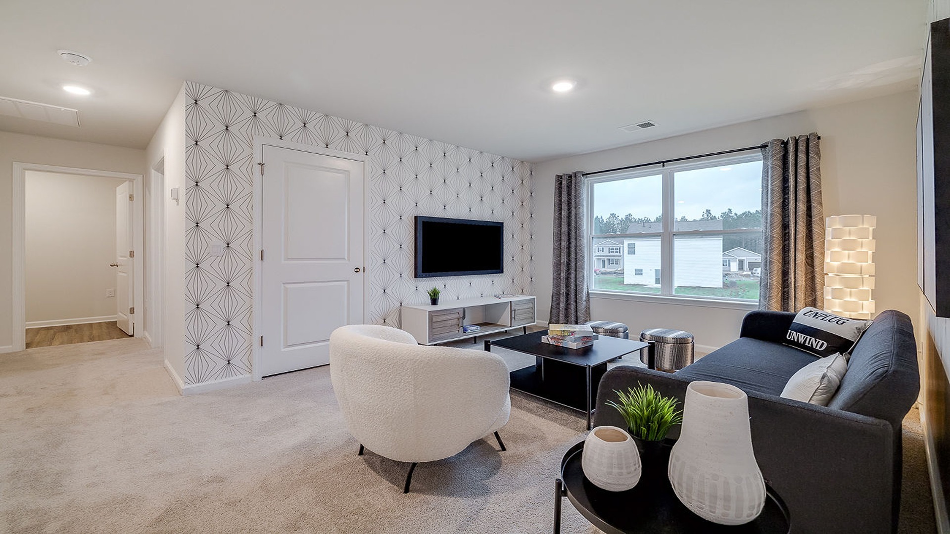 Upstairs living room with a couch, chairs and tv