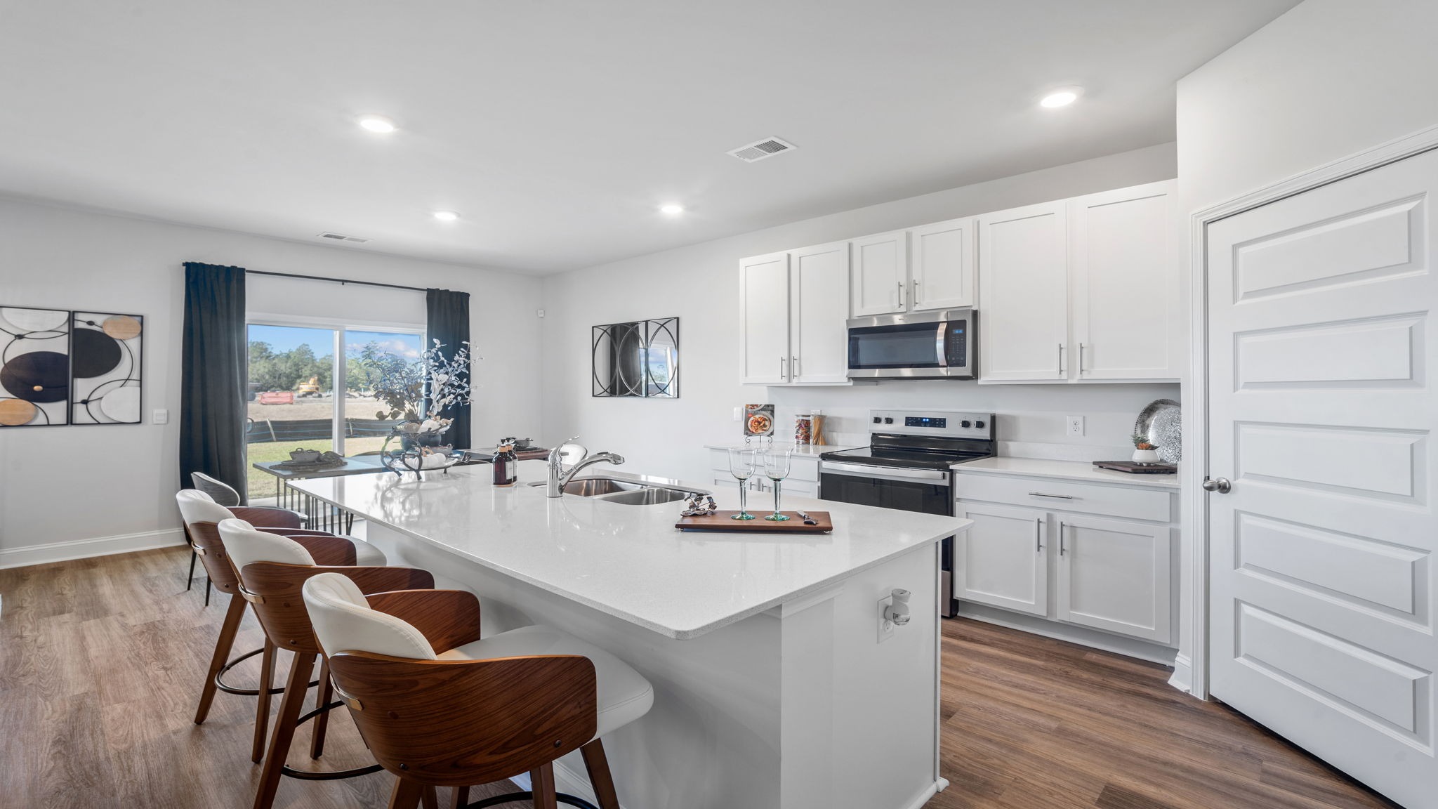 Gourmet kitchen in the Hayden floor plan featuring granite countertops, stainless steel appliances, abundant cabinetry, and a spacious center island.