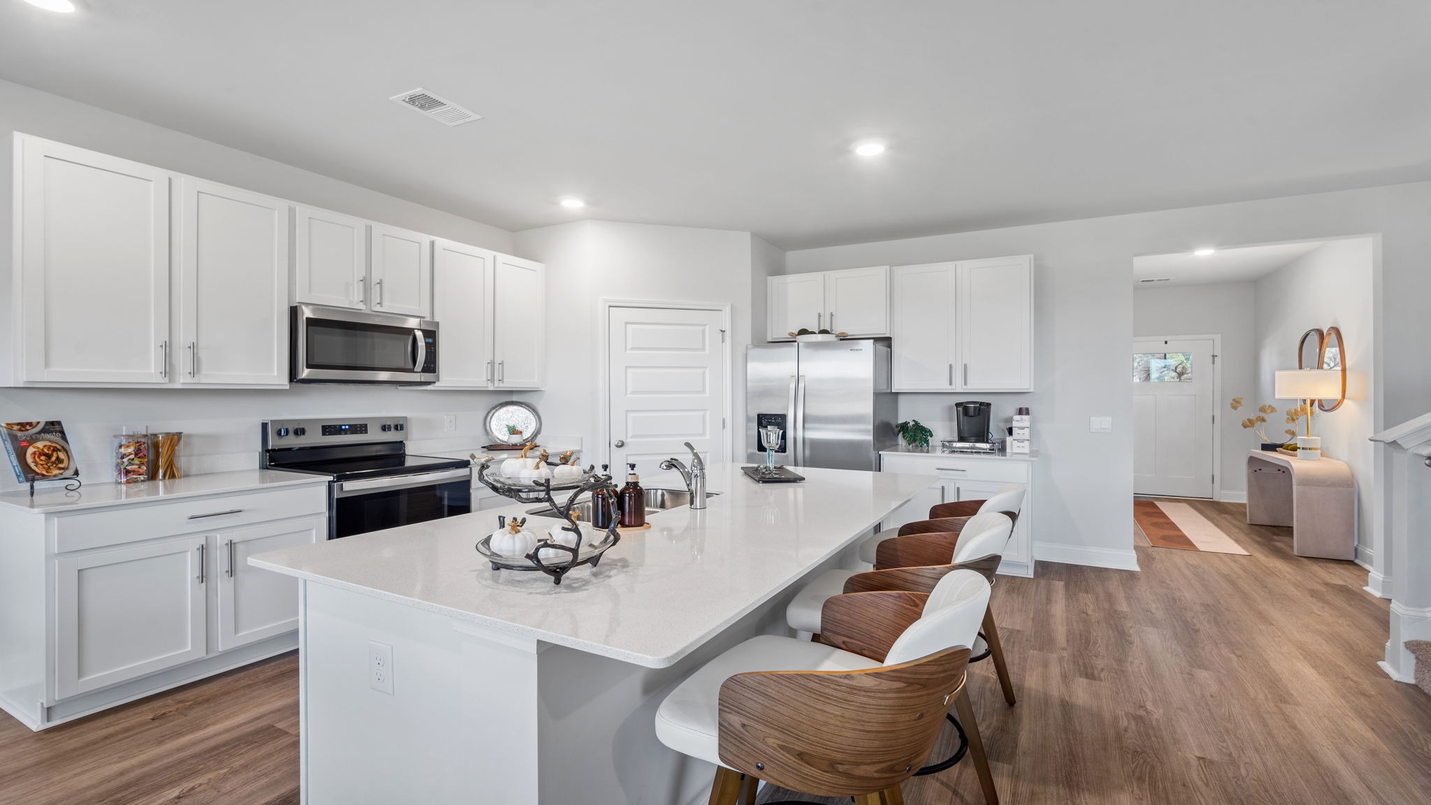 Oversized center island featuring granite countertops and open views throughout the main living area.