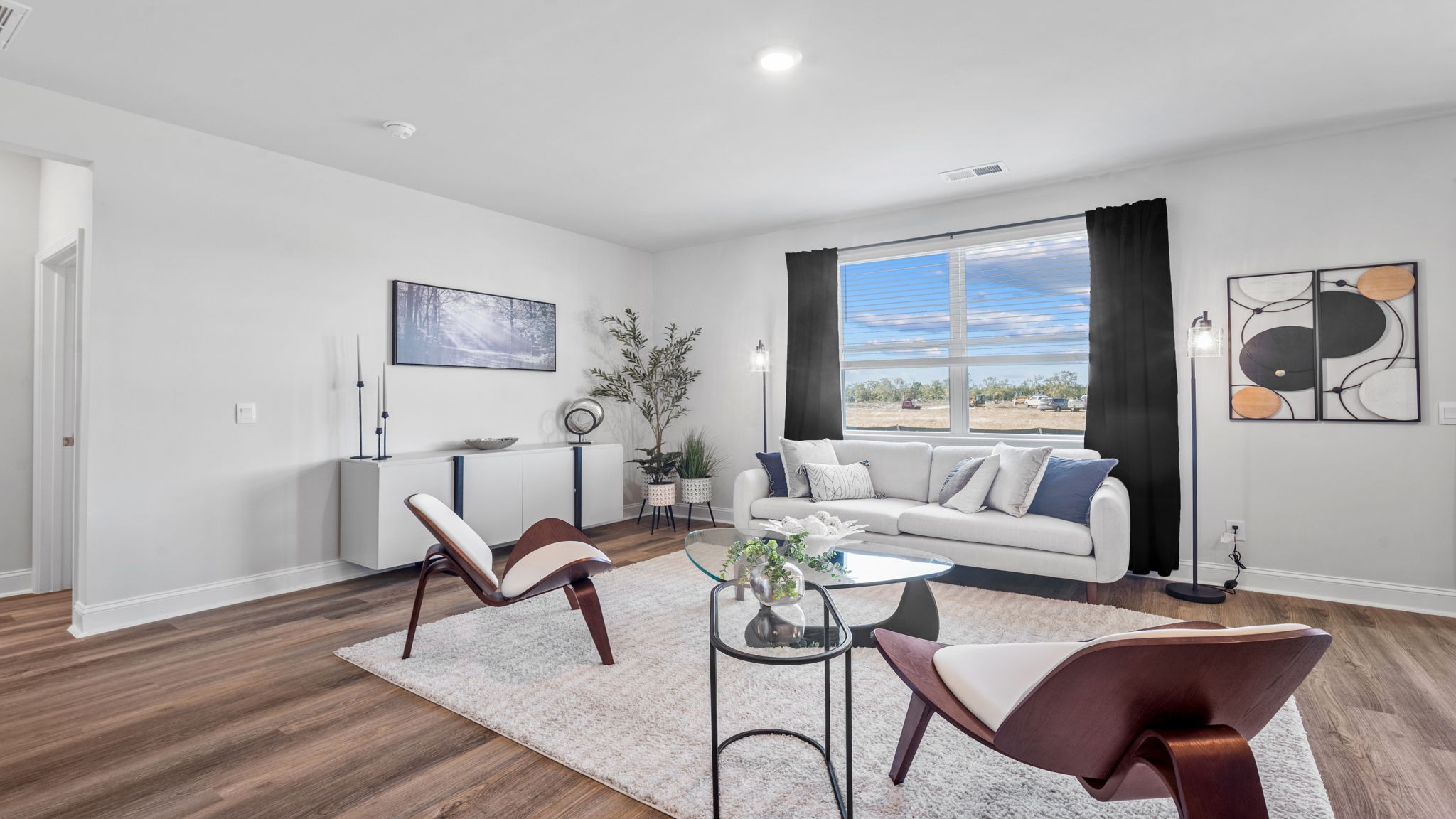 Inviting living area with modern finishes and seamless access to the kitchen and dining room.