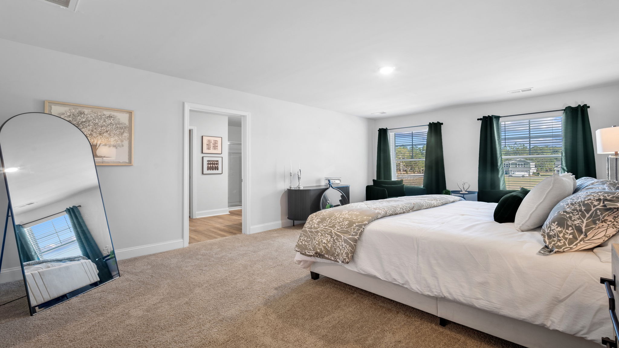 Beautiful owner's suite featuring large windows, abundant natural light, and exceptional comfort.