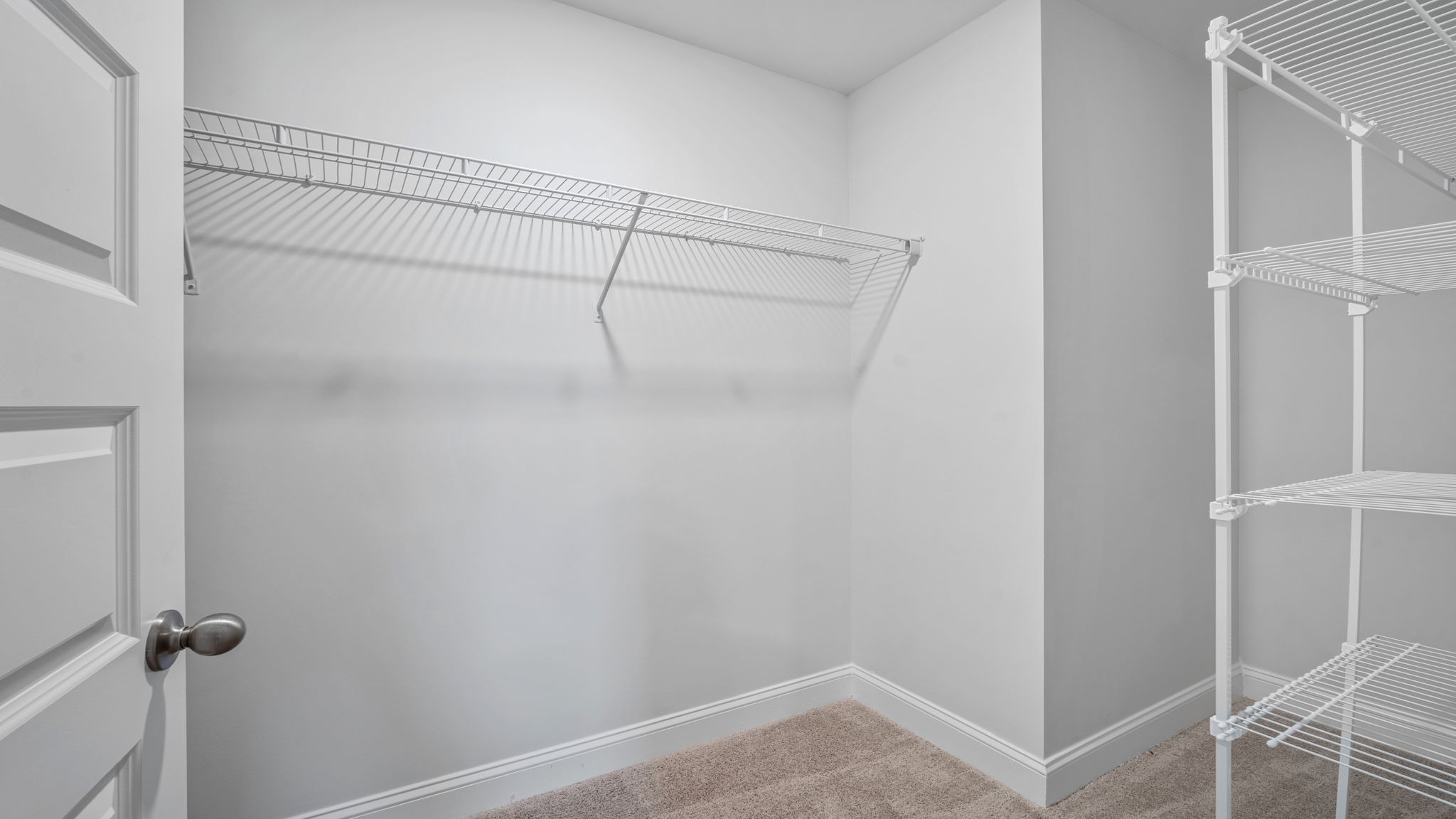 Expansive walk-in closet in the Hayden floor plan providing abundant storage space and convenient access from the owner's suite.