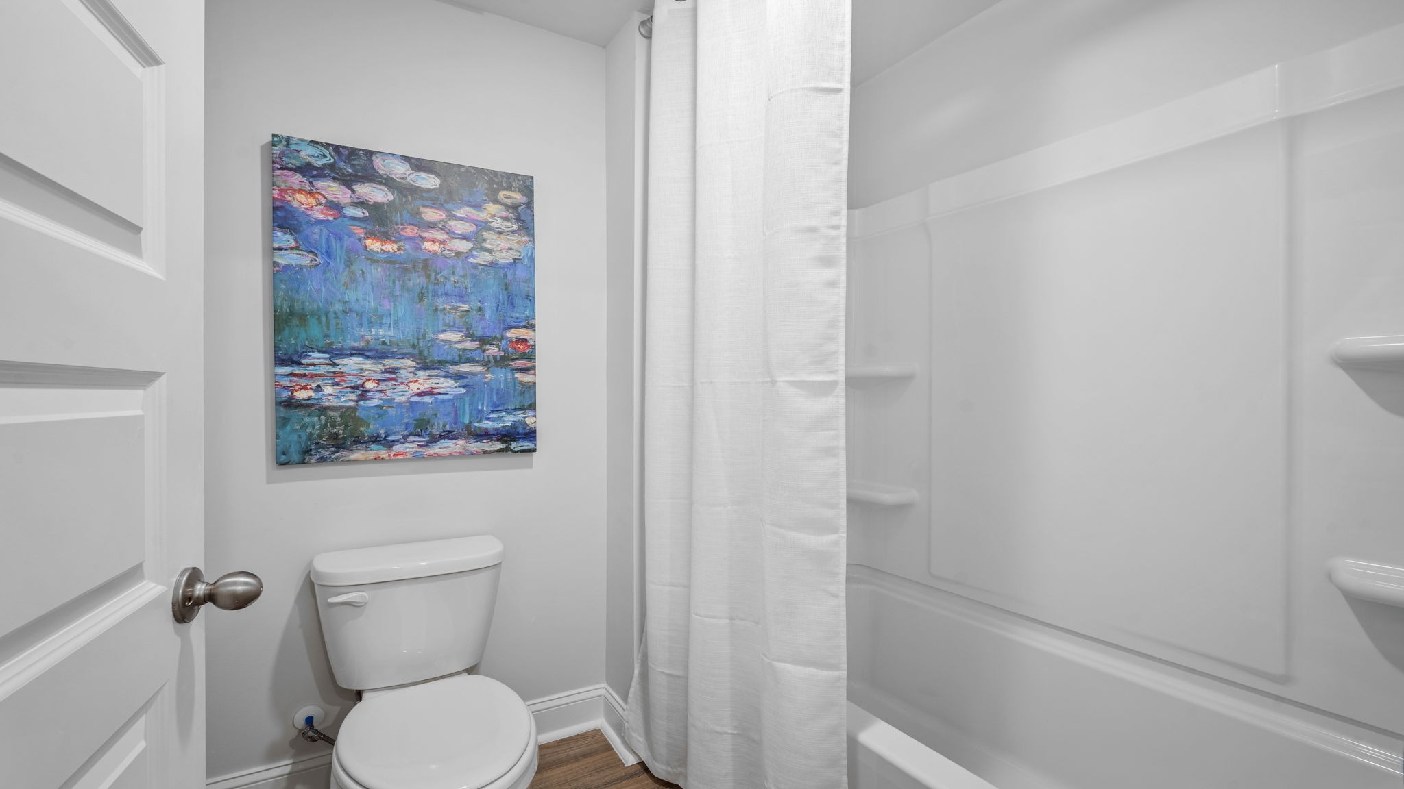 Bright secondary bathroom with modern finishes and everyday convenience in the Hayden floor plan.