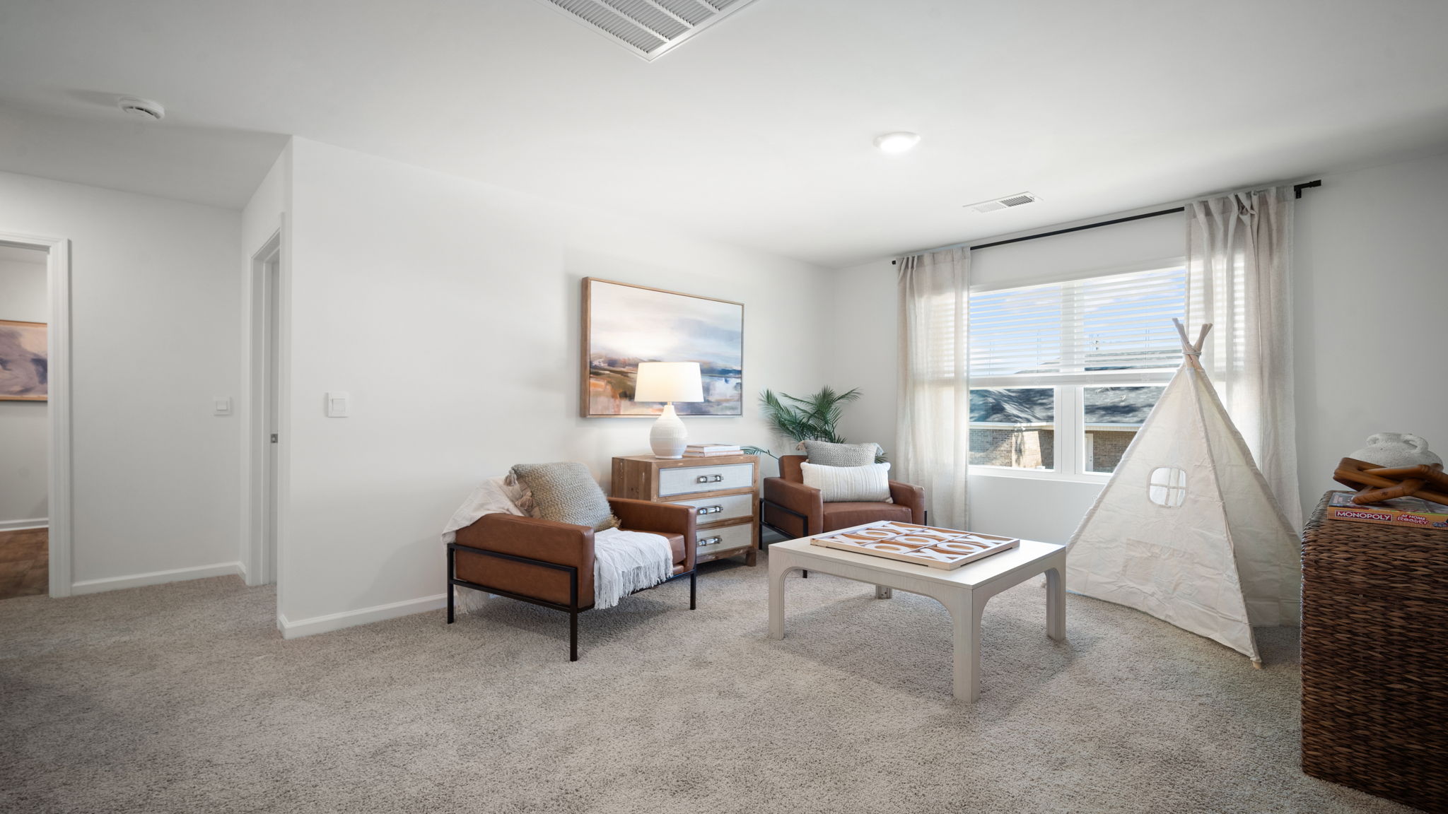 Upstairs living room with a couch, chairs and tv