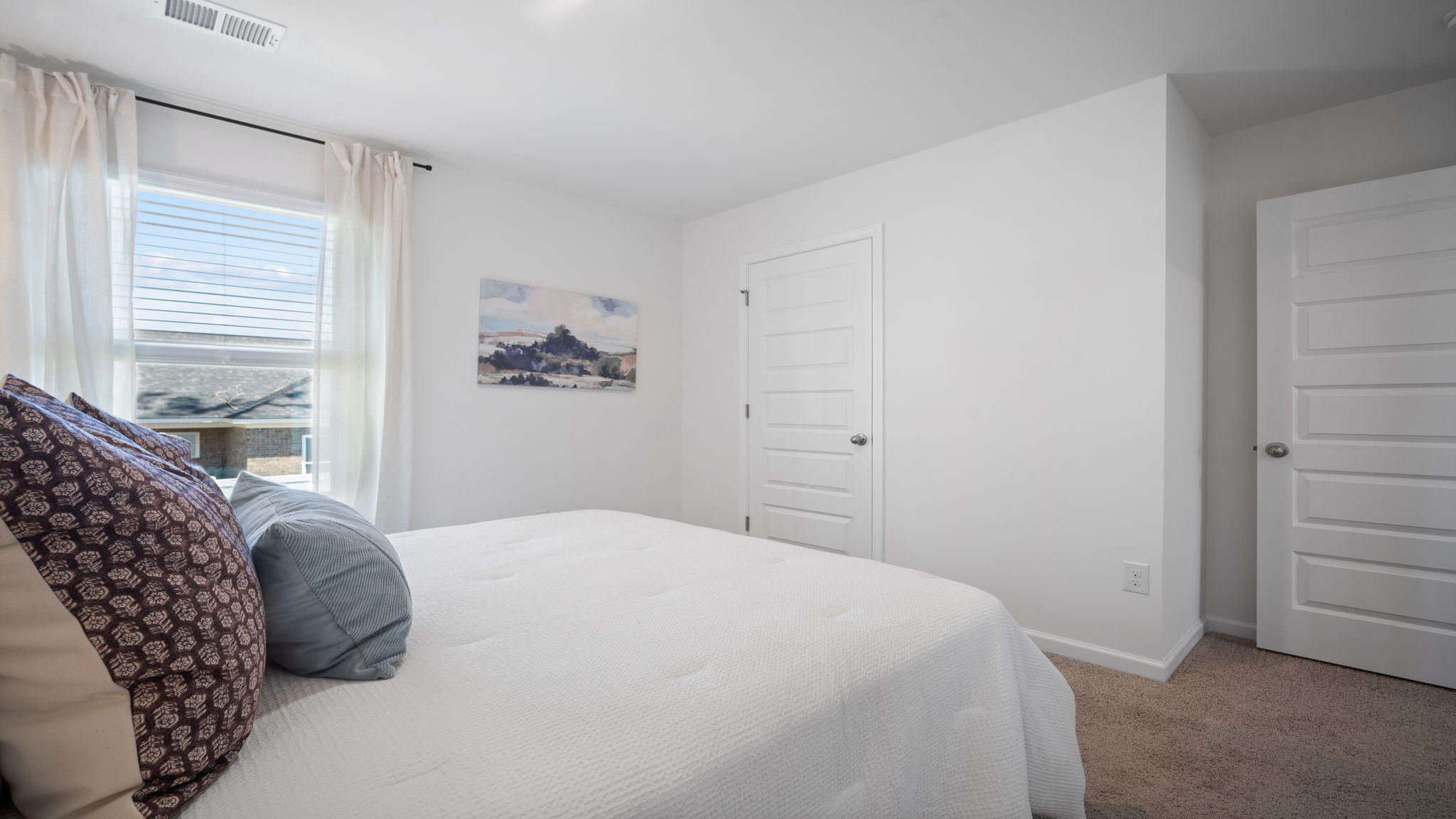 Guest bedroom with a bed and a chair