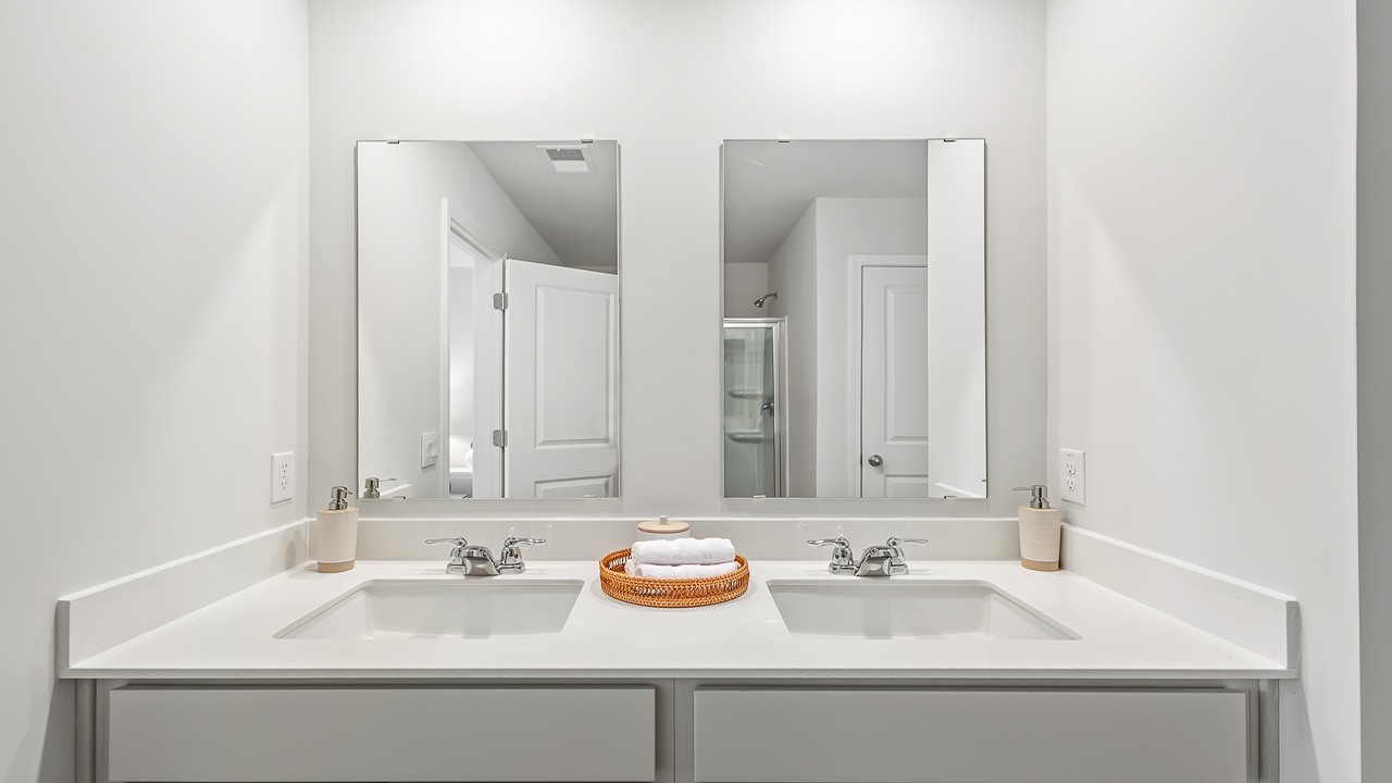 Spa-inspired owner's bath in the Denmark home showcasing modern fixtures, ample counter space, and stylish design.