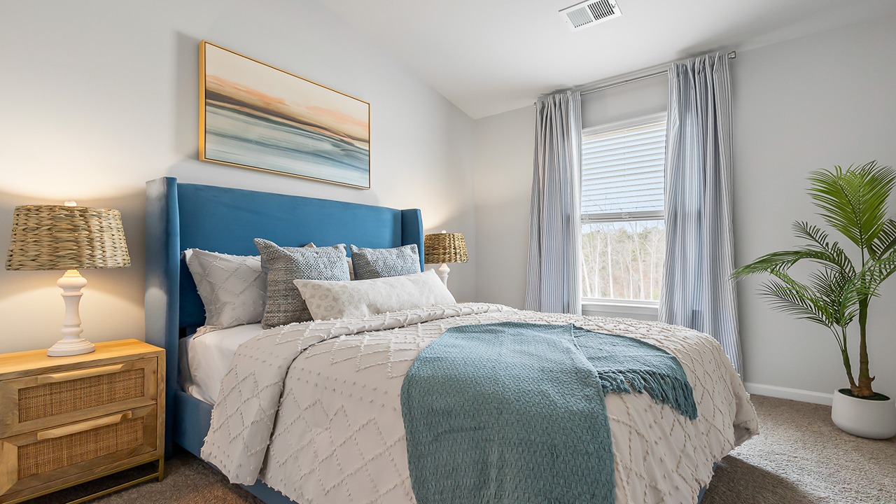 Comfortable secondary bedroom in the Denmark floor plan featuring natural light, ample closet space, and versatile functionality.