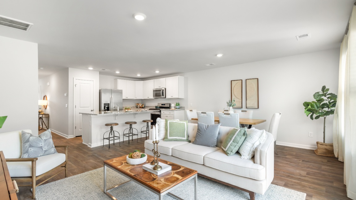 Spacious family room in the Davis floor plan showcasing contemporary design and open sightlines to the kitchen and dining area.
