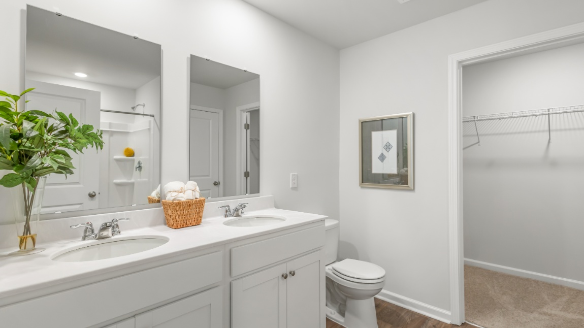 Luxury primary bathroom in the Davis floor plan at Old Bailey featuring dual vanities, walk-in shower, and elegant finishes.