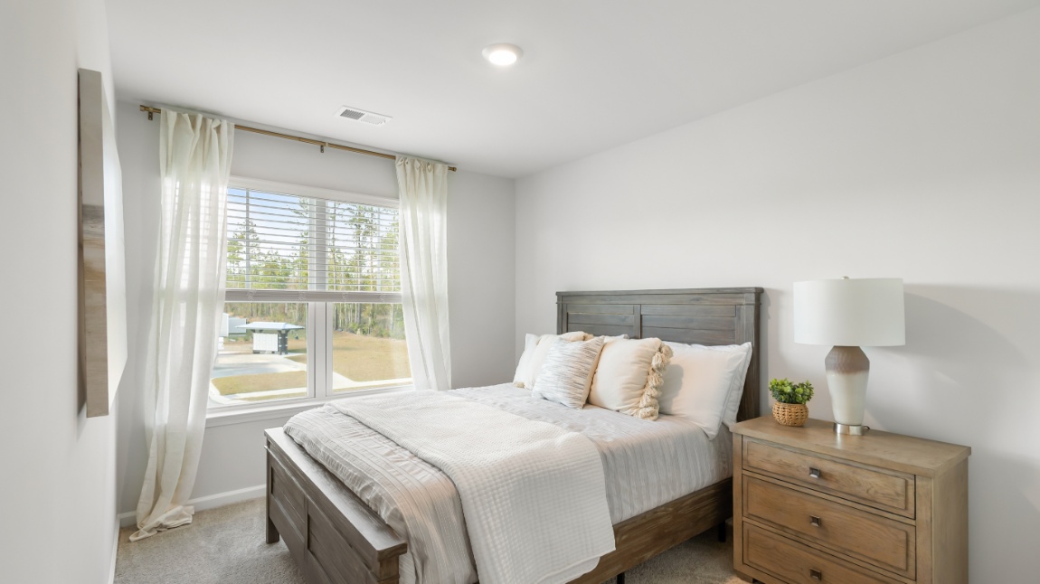 Comfortable secondary bedroom in the Davis floor plan featuring natural light, closet space, and versatile functionality.