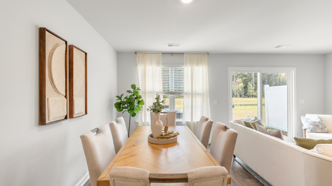 Dining area in the Davis floor plan featuring an open layout, elegant design, and convenient access to the kitchen and living room.