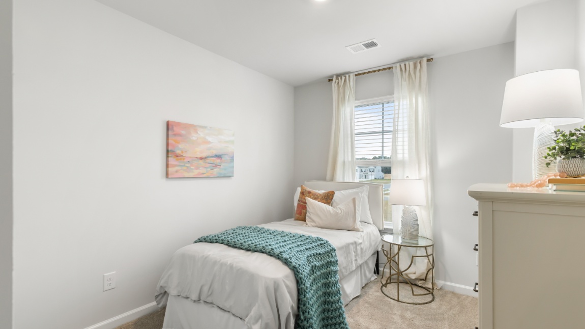 Guest bedroom in the Davis home ideal for family members, visitors, or a private home office.