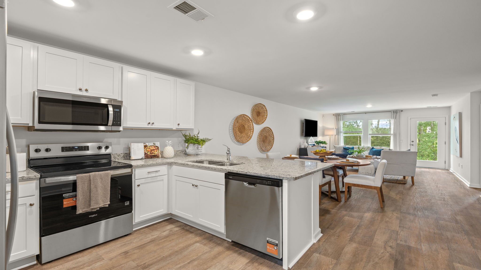 Open-concept kitchen and living area in the Norman townhome featuring large island, stainless steel appliances, and spacious gathering space