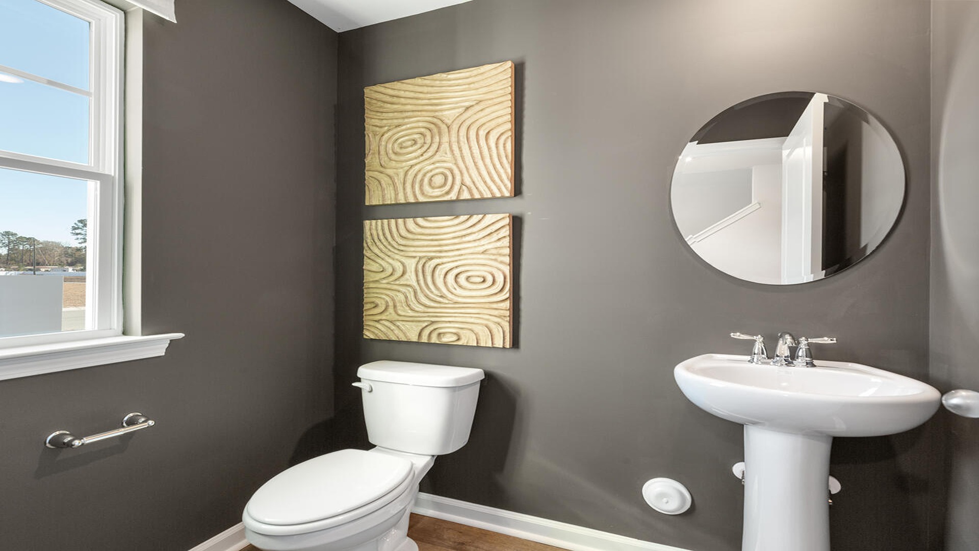 Elegant powder room in the Norman floor plan at Old Bailey by D.R. Horton featuring modern fixtures, stylish finishes, and convenient first-floor access.