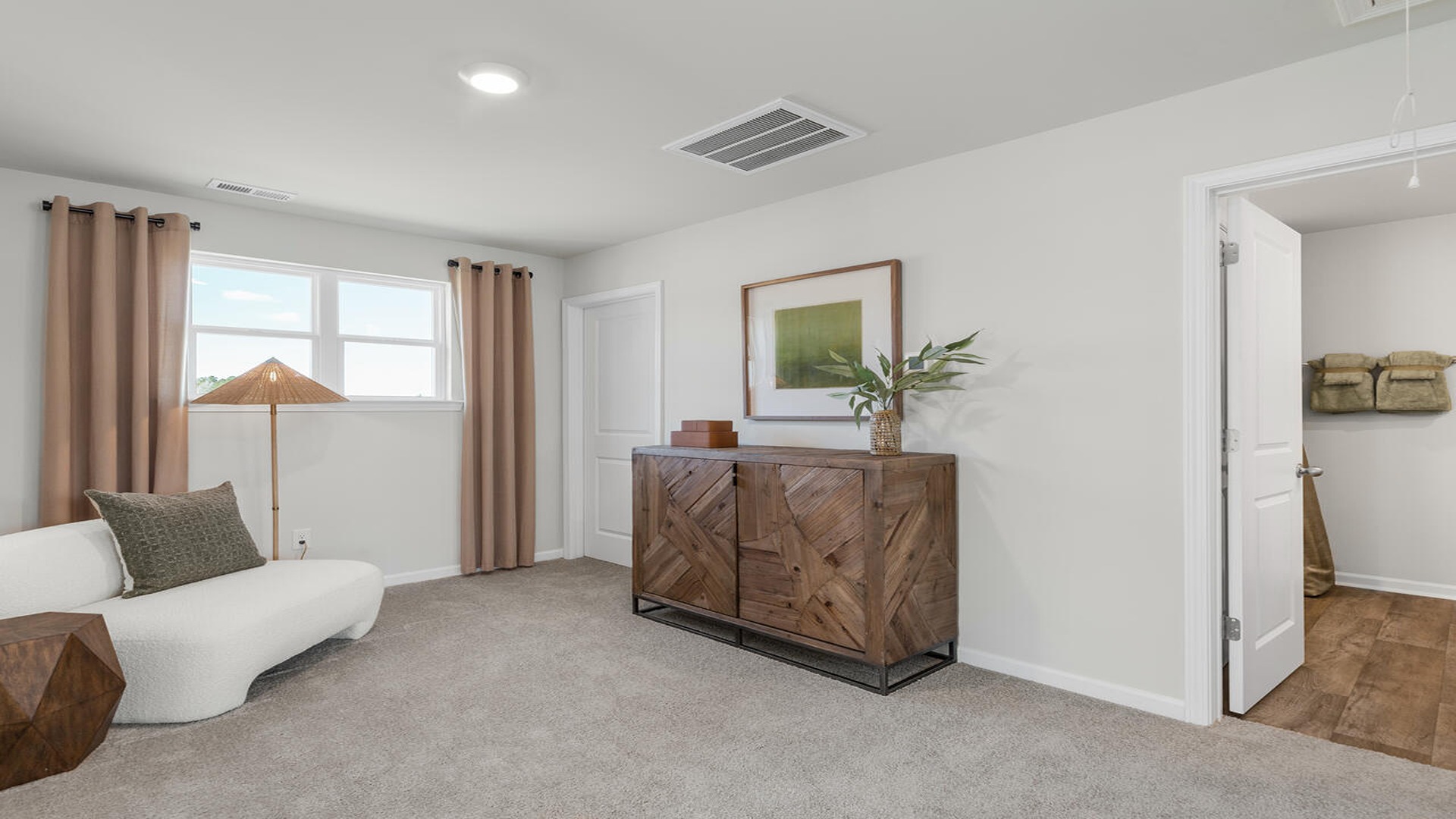 Versatile loft space in the Norman floor plan ideal for a media room, playroom, home office, or additional living area.
