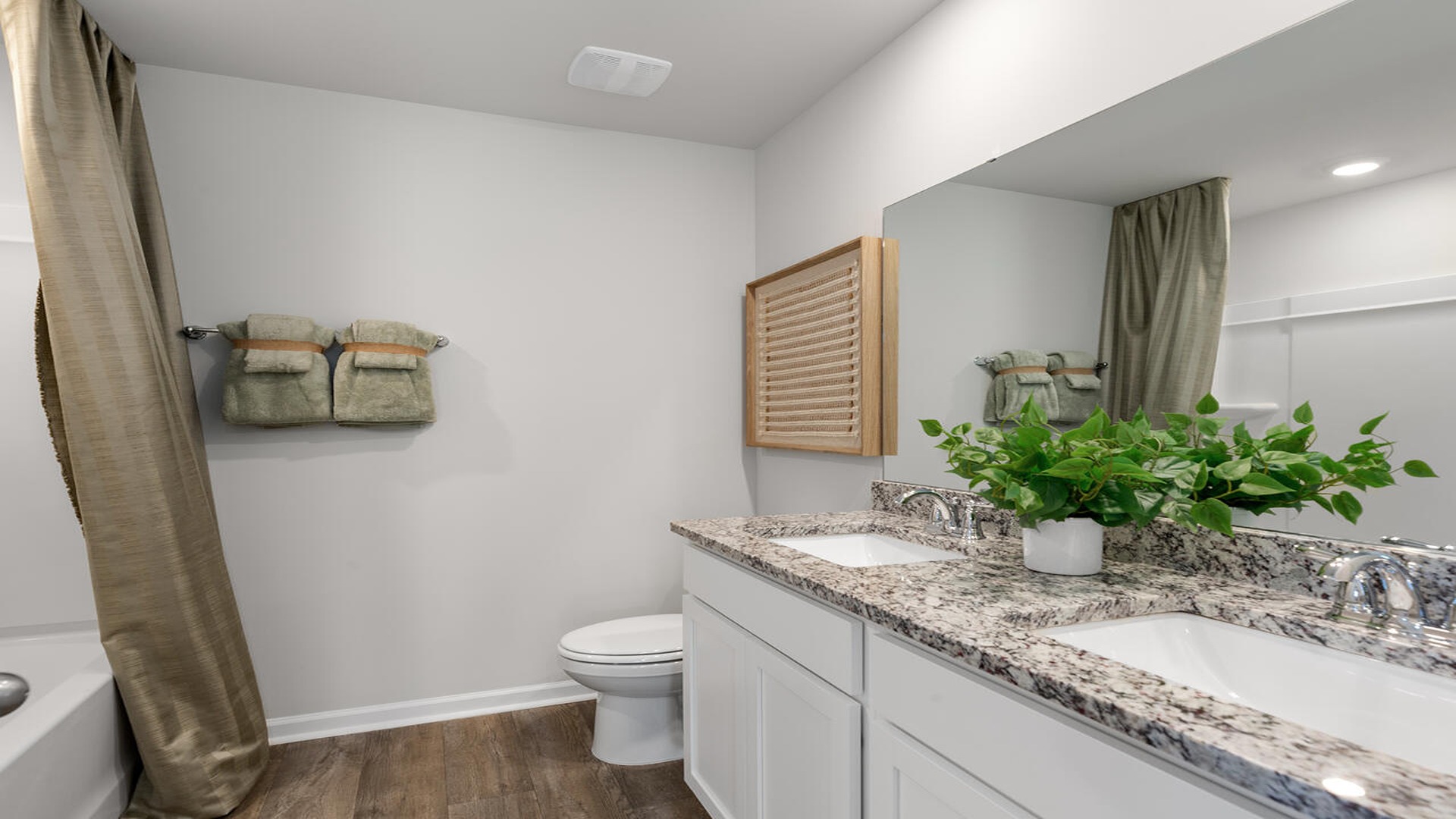 Spacious guest bathroom in the Norman floor plan at Old Bailey featuring a modern vanity, ample counter space, and contemporary finishes.