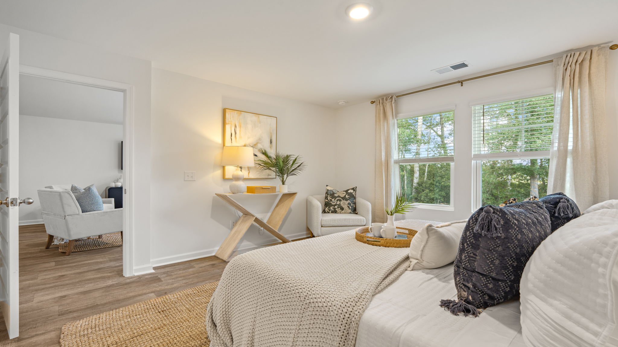 Spacious primary bedroom in the Norman townhome with adjoining bath and walk-in closet access
