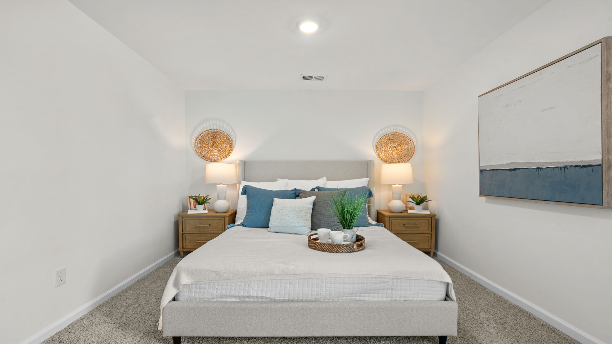 Secondary bedroom in the Norman townhome with natural light, closet storage, and flexible use options