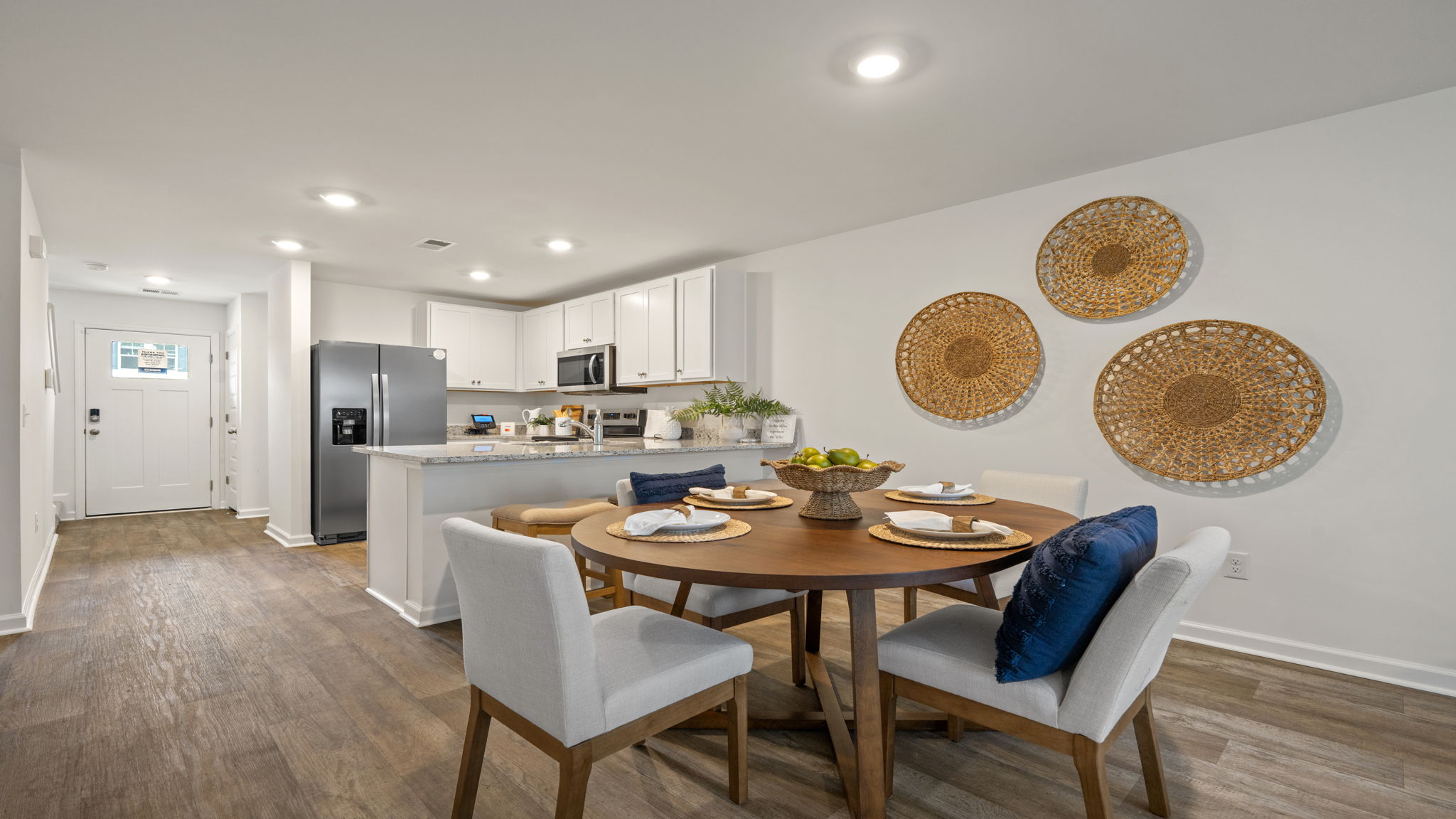 Dining area and kitchen in the Norman townhome with open layout, island seating, and contemporary finishes