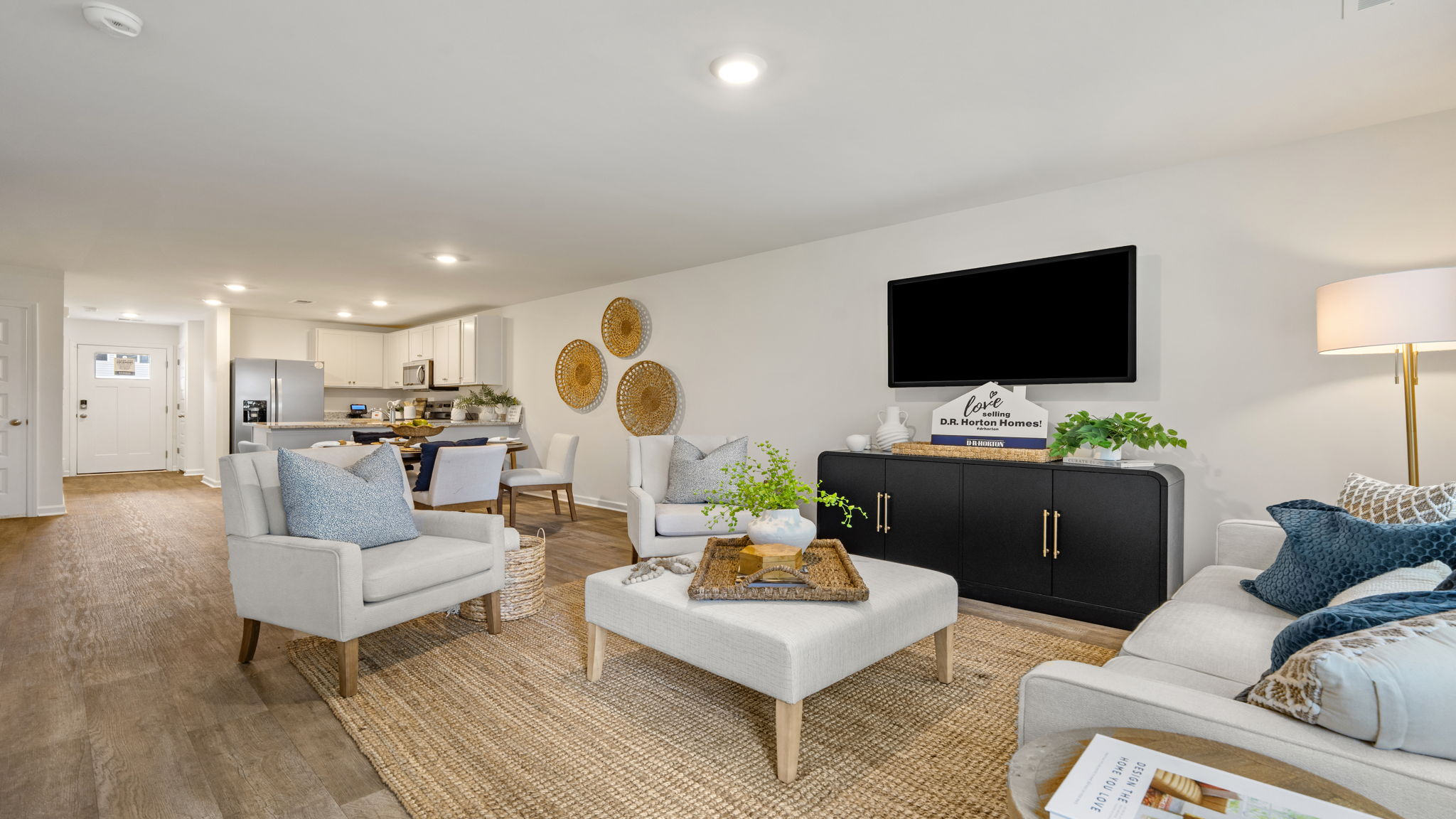 Bright family room in the Norman townhome with open living space, large windows, and seamless flow to the kitchen